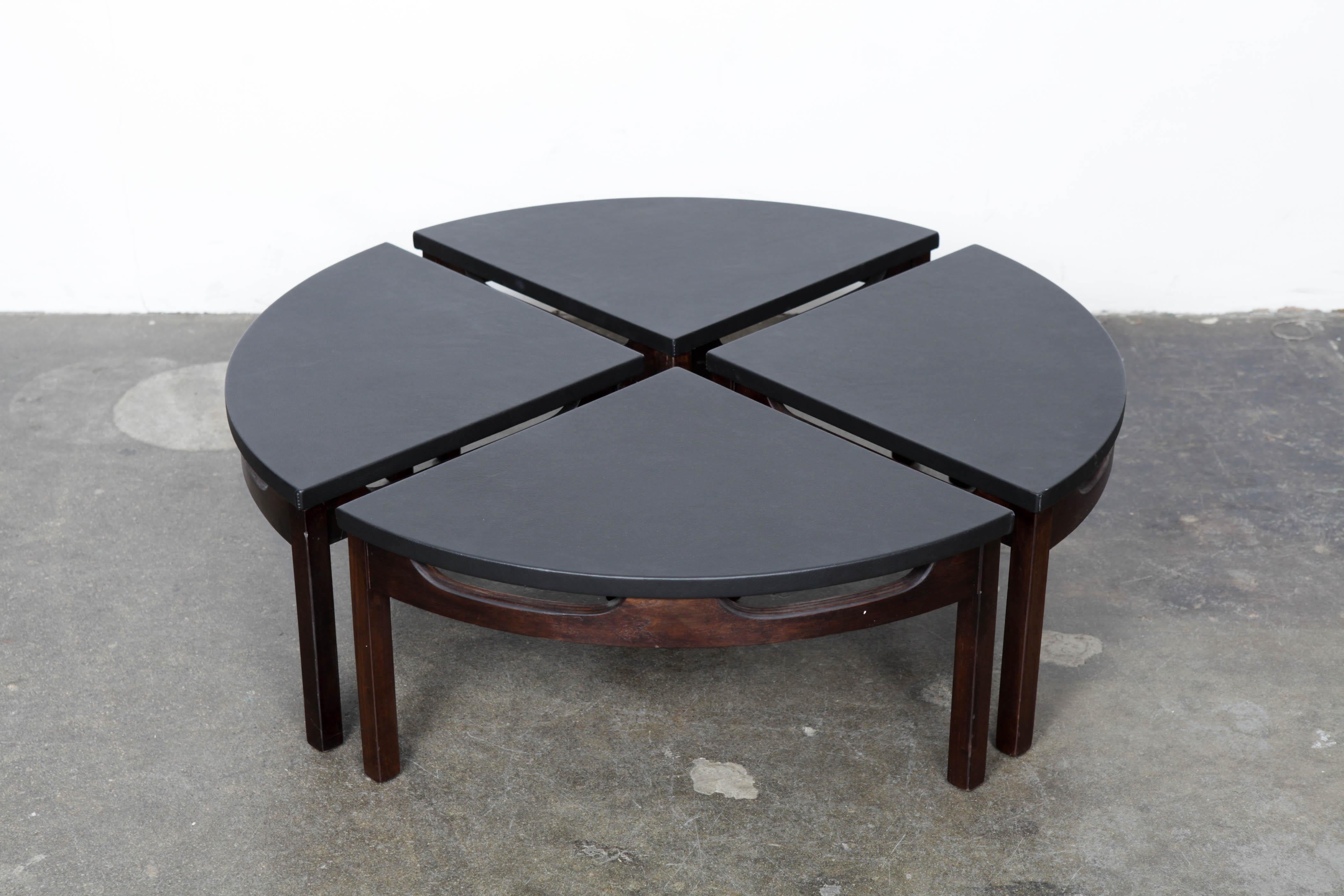 Unique walnut and leather top round coffee table, 1960s, that separates into 4 pie shaped individual table parts, USA. Leather was recently replaced and in excellent condition. Designer or maker unknown.