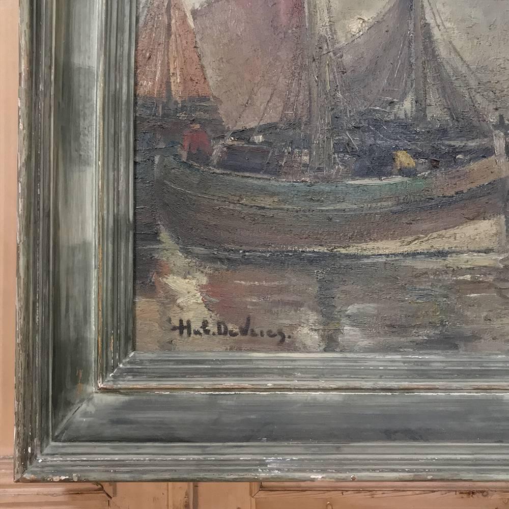 Antique Framed Oil Painting on Board by Hubert De Vries (1899-1979) depicts a quiet harbor scene after the fishing fleet has returned from a busy day out at sea.  Original painted frame adds an elegant yet rustic charm. Art painter Hubert De Vries,