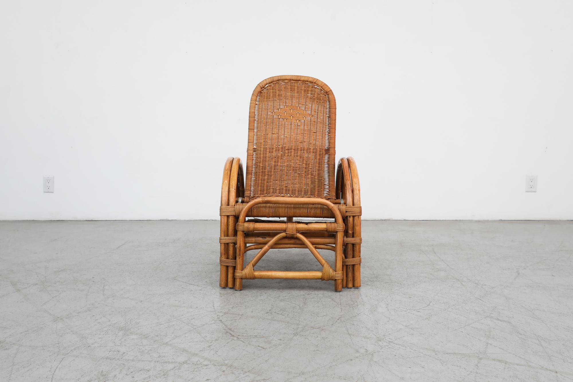 Gorgeous Franco Albini Inspired Mid-Century bamboo lounge chair to chaise with woven rattan seating and built in ottoman. The chair has an adjustable back and an attached ottoman that slides out from underneath the seat to make a chaise lounge. It's