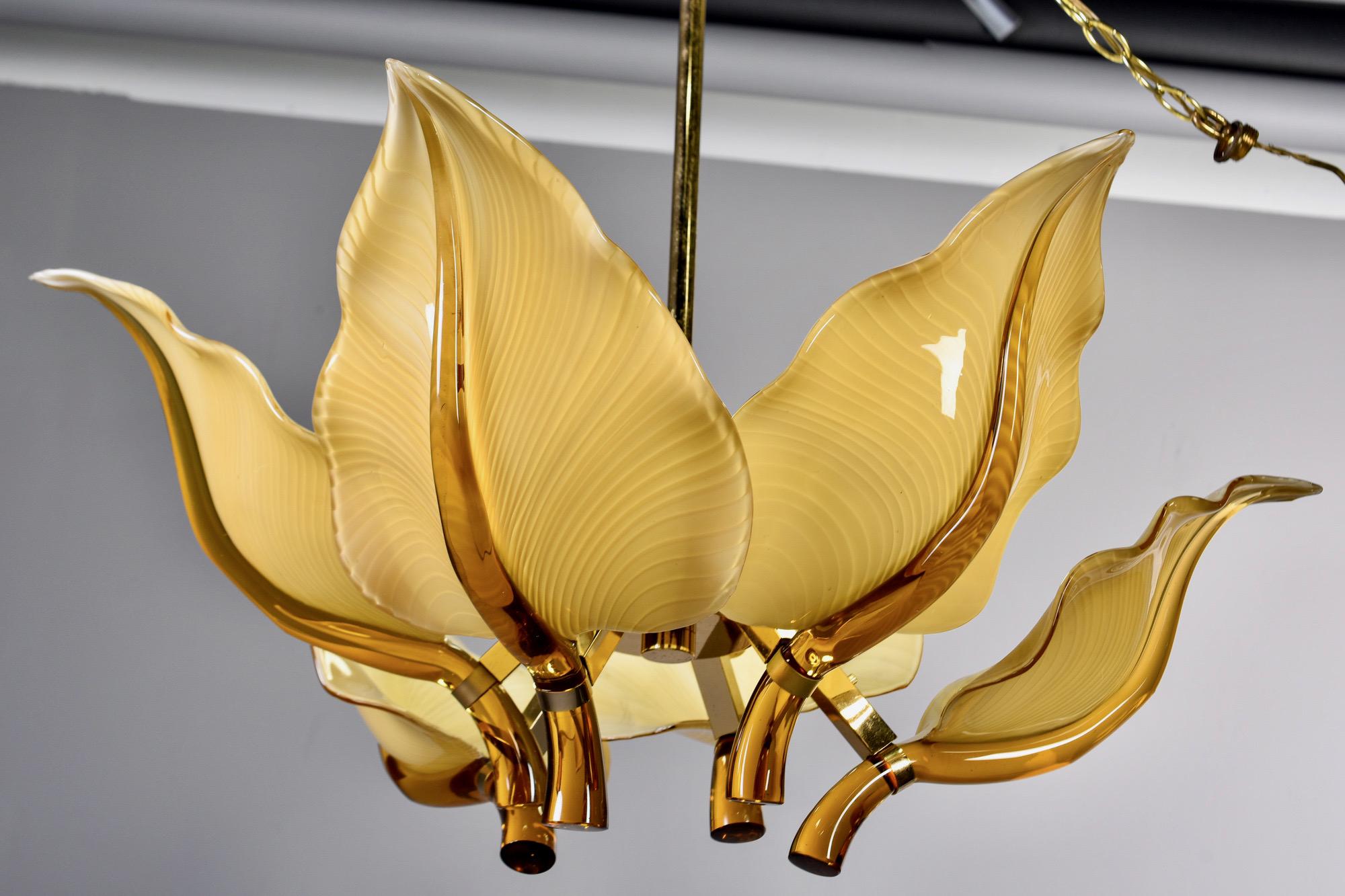 Murano glass fixture designed by Franco Luce for Seguso, circa 1970s. Polished brass frame supports six amber colored mouth blown glass leaves. Fixture has six standard sized sockets. 

Measurement above is from bottom of fixture to top of the