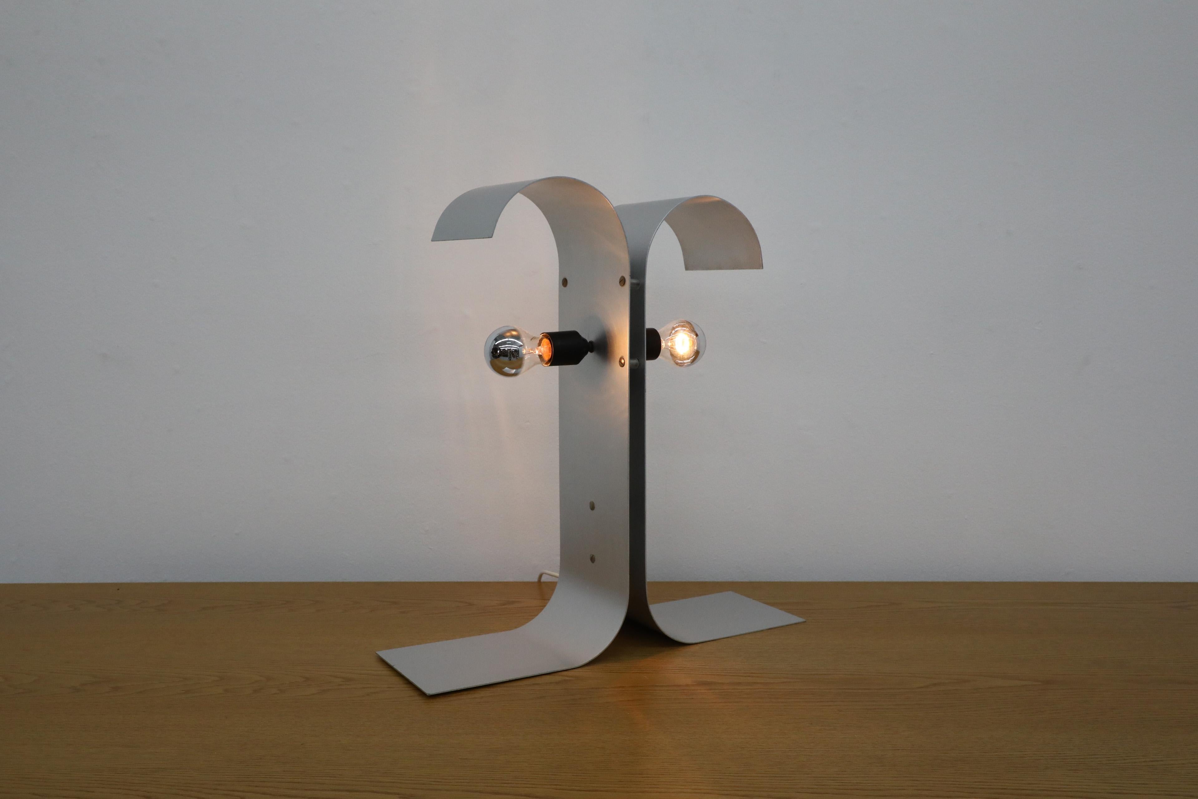 Incredible Francois Monnet inspired bent metal table lamp. A Mid-Century Modern lamp with space age design and eye catching style. In original condition with wear and scratching consistent with age and use.