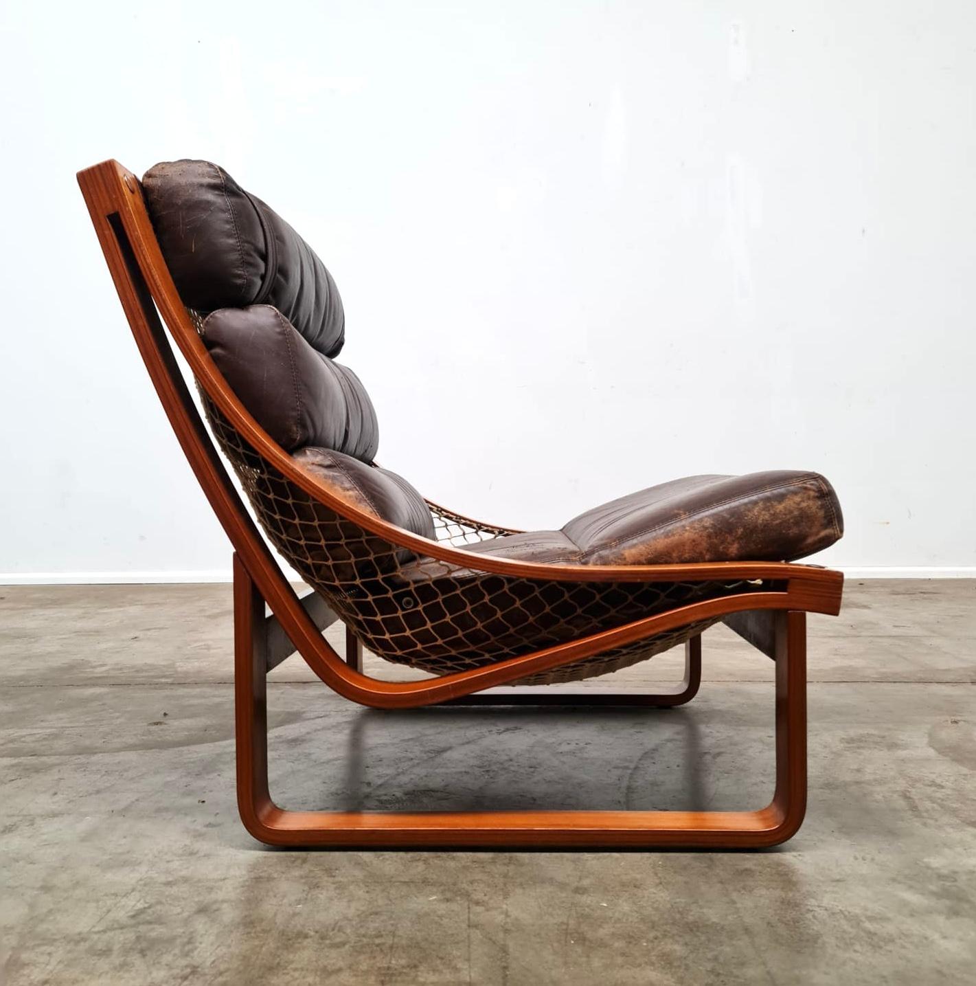 Tessa T4 lounge designed for Tessa Furniture by Fred Lowen. Bent ply Teak frames with a suspended hammock back supporting original leather cushions.

Frames have been Cleaned and polished. The leather has been cleaned and conditioned with one small
