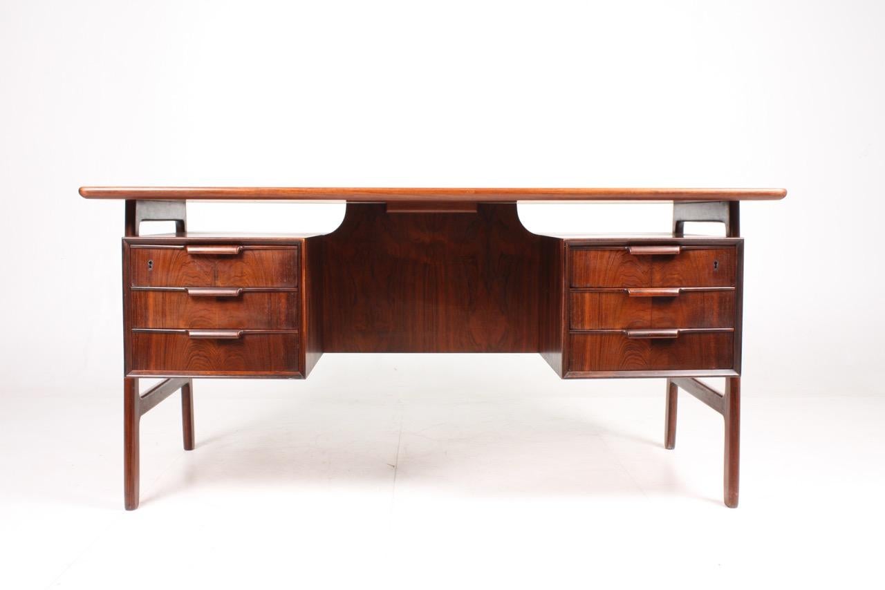 Great looking freestanding desk in rosewood designed by Gunni Oman for Oman Jun, Denmark in 1957. Great original condition.