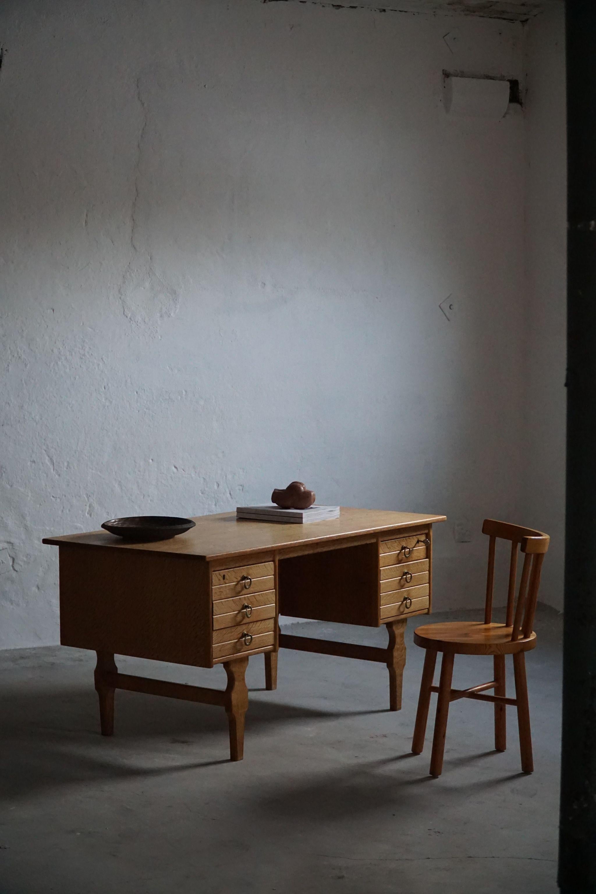 Mid-century freestanding desk in solid oak and with brass handles. Made by a Danish cabinetmaker in 1950s.

Nice curves for this perfect office desk. Overall a great impression.
This piece is in a very good vintage condition.

With a heavy