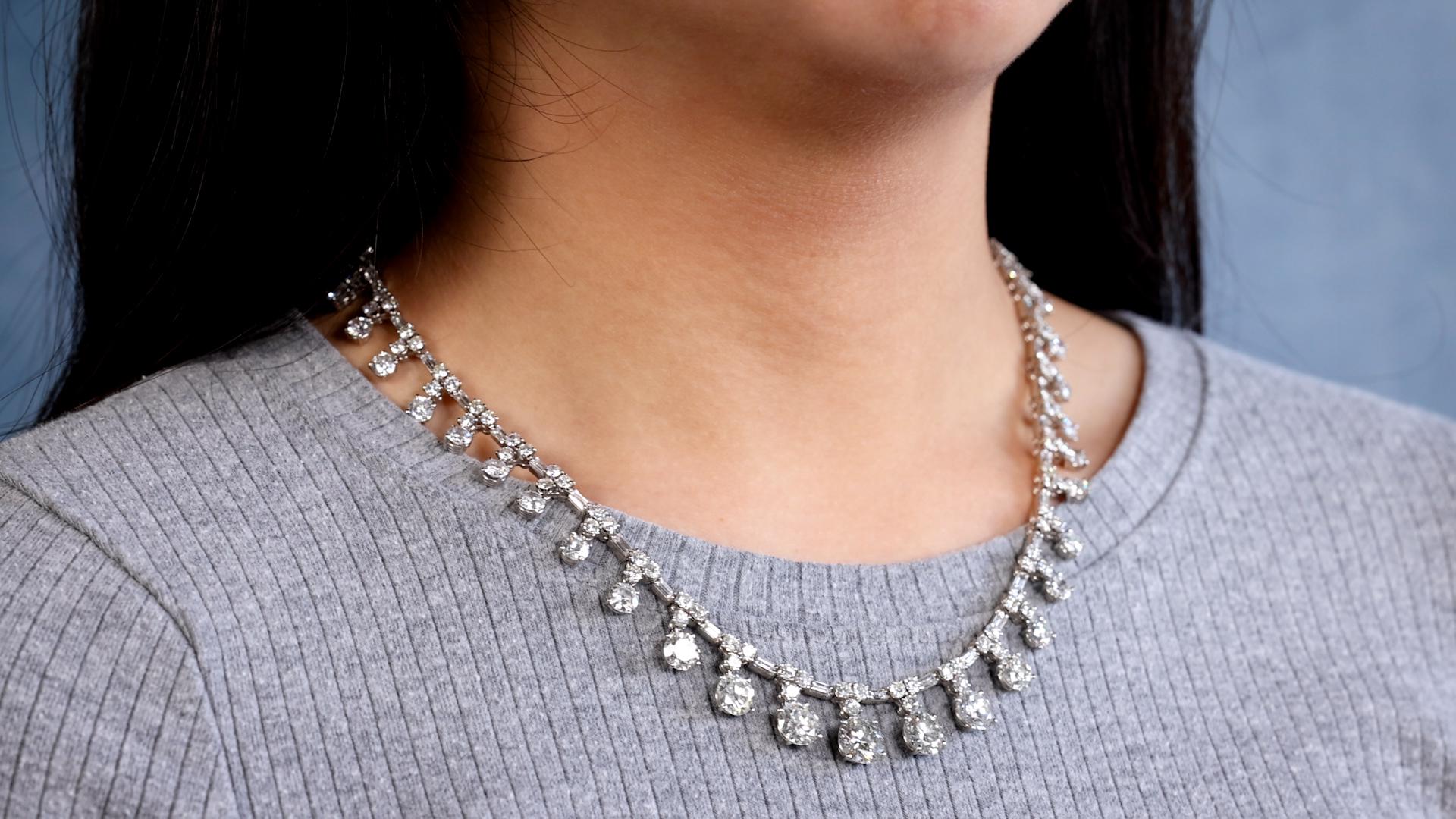 One Mid-Century French 33.30 Carat Total Weight Platinum Rivière Drop Necklace. Featuring seven transitional and round brilliant cut diamonds weighing approximately 1.02 carats, 1.30 carats, 1.78 carats, 2.23 carats, 1.74 carats, 1.55 carats, and