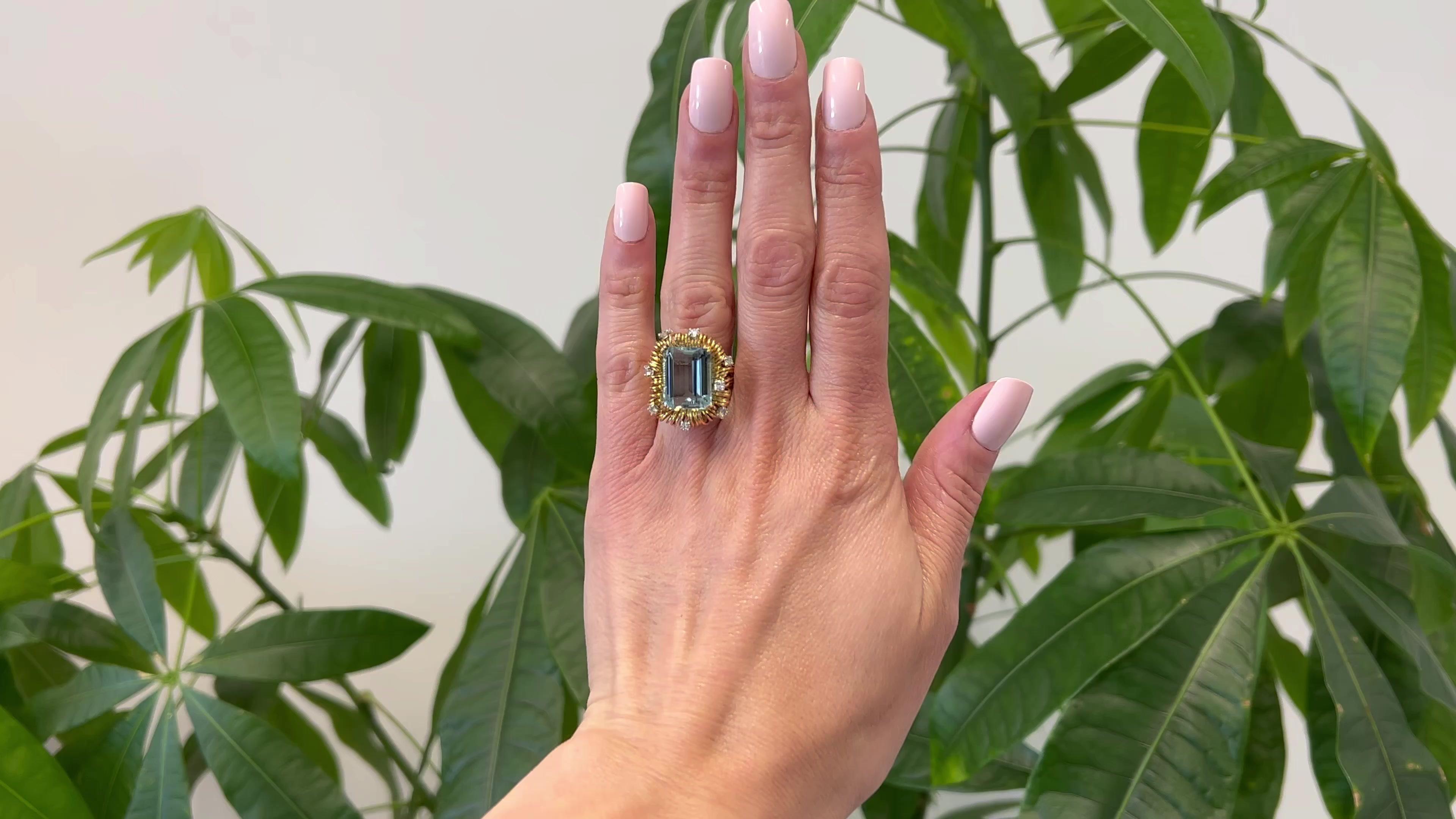 One Mid Century French Aquamarine Diamond 18k Yellow Gold Cocktail Ring. Featuring one octagonal step cut aquamarine weighing approximately 8.65 carats. Accented by eight round brilliant cut diamonds with a total weight of approximately 0.55 carats,