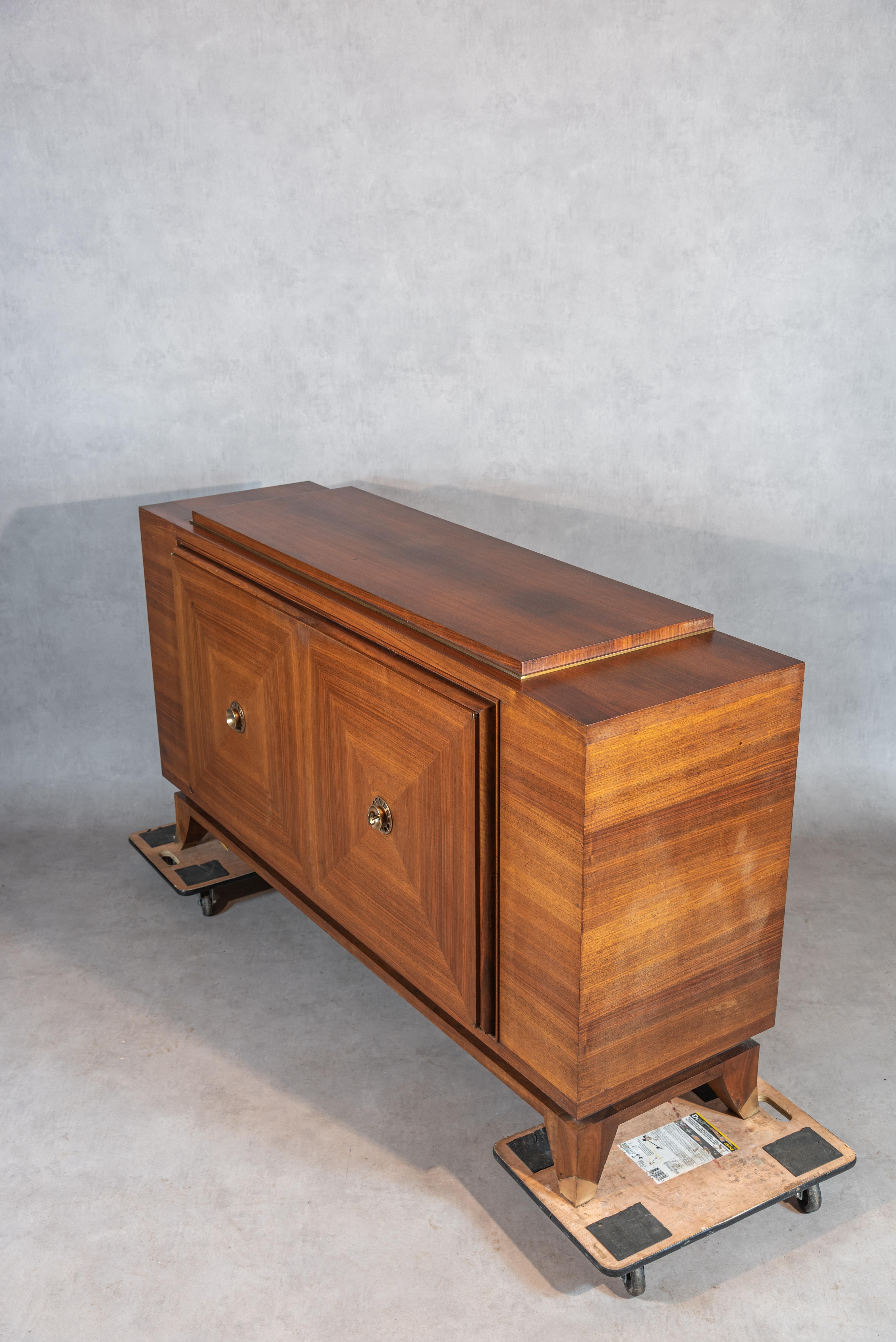 Experience the exceptional beauty and craftsmanship of this midcentury French Art Deco Enfilade, inspired by the renowned Jules Leleu. Crafted from rich mahogany veneer, this Enfilade boasts squared book match motifs and refined craftsmanship,