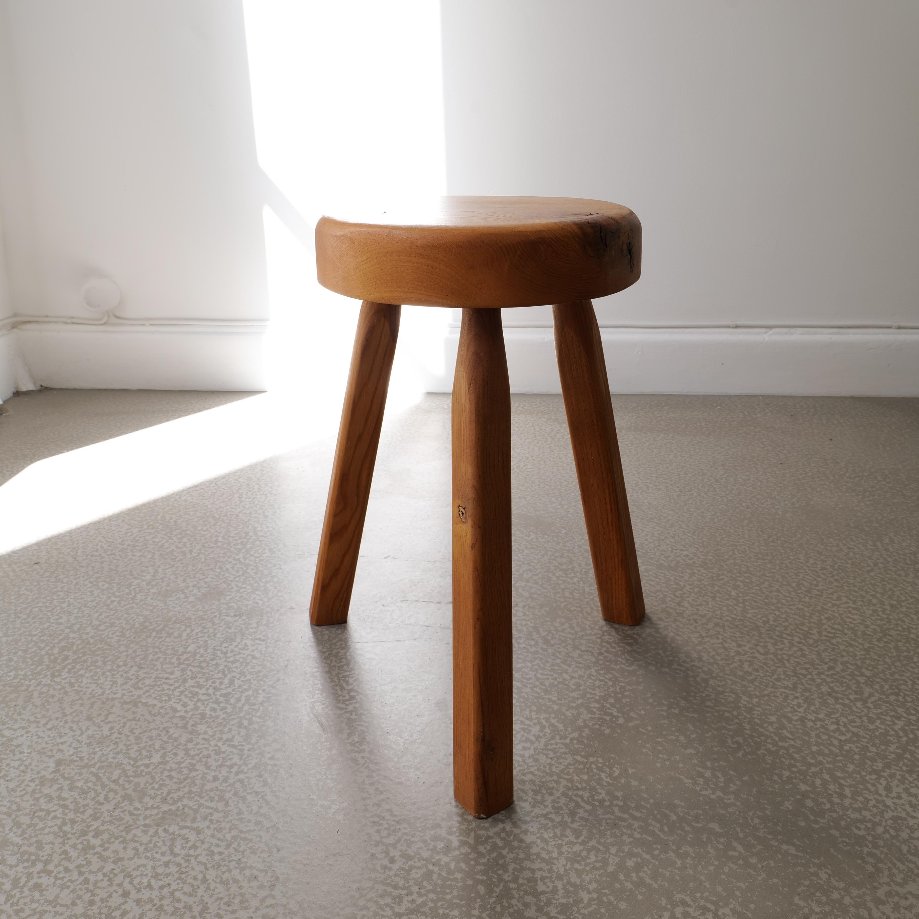 A beautifully crafted Ash wood stool with a sculptural and organic shaped seat and lovely wood knots adding character and warmth.  The legs are tall and statuesque with square smooth edges and the stool is solid, heavy and stable with minimal marks