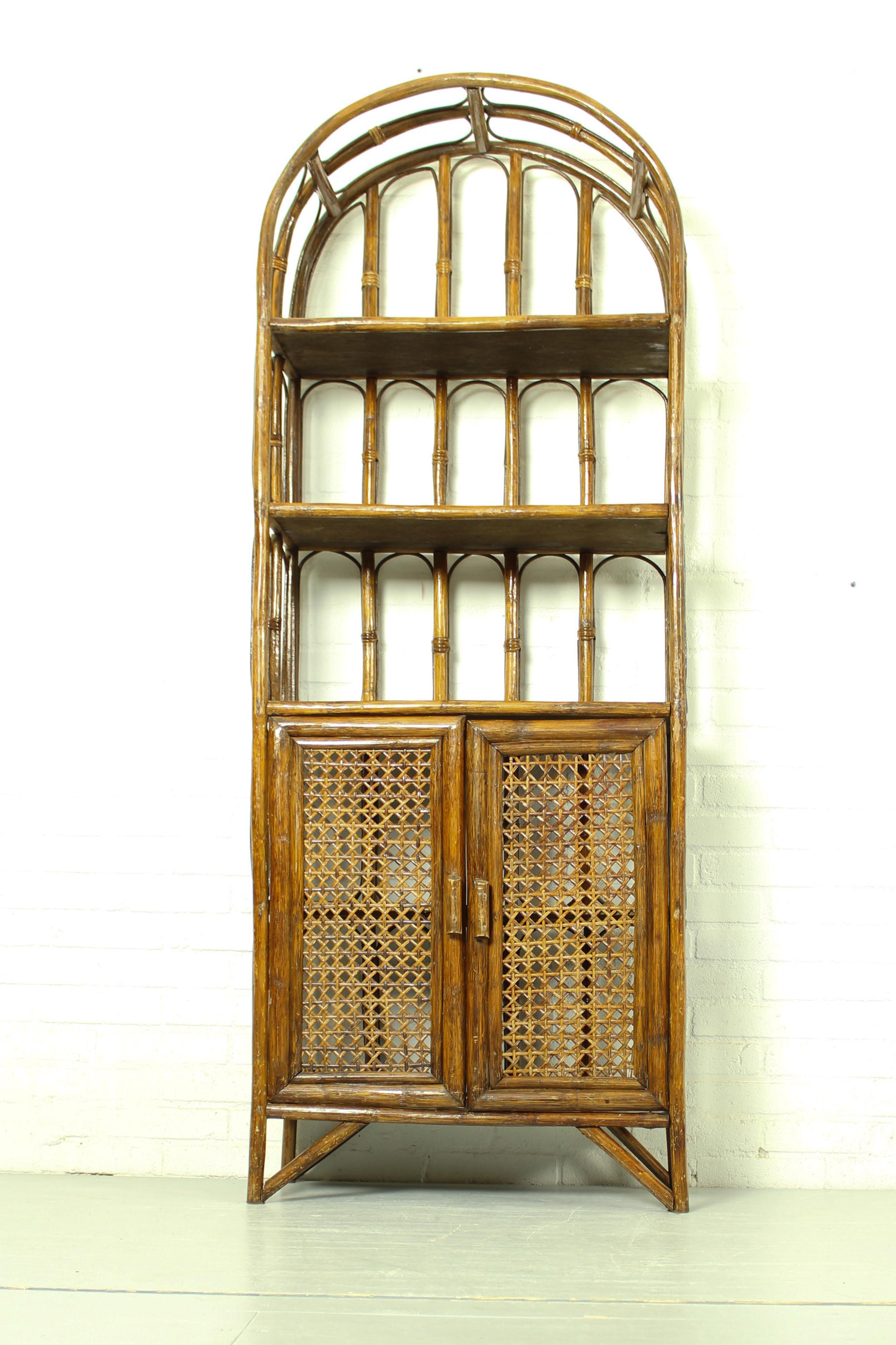 Beautiful bamboo and rattan medium brown bamboo shelves with doors, in the style of Maison Baguès. French, circa 1960. 

Dimensions: 173cm h, 66cm w and 28cm d.
