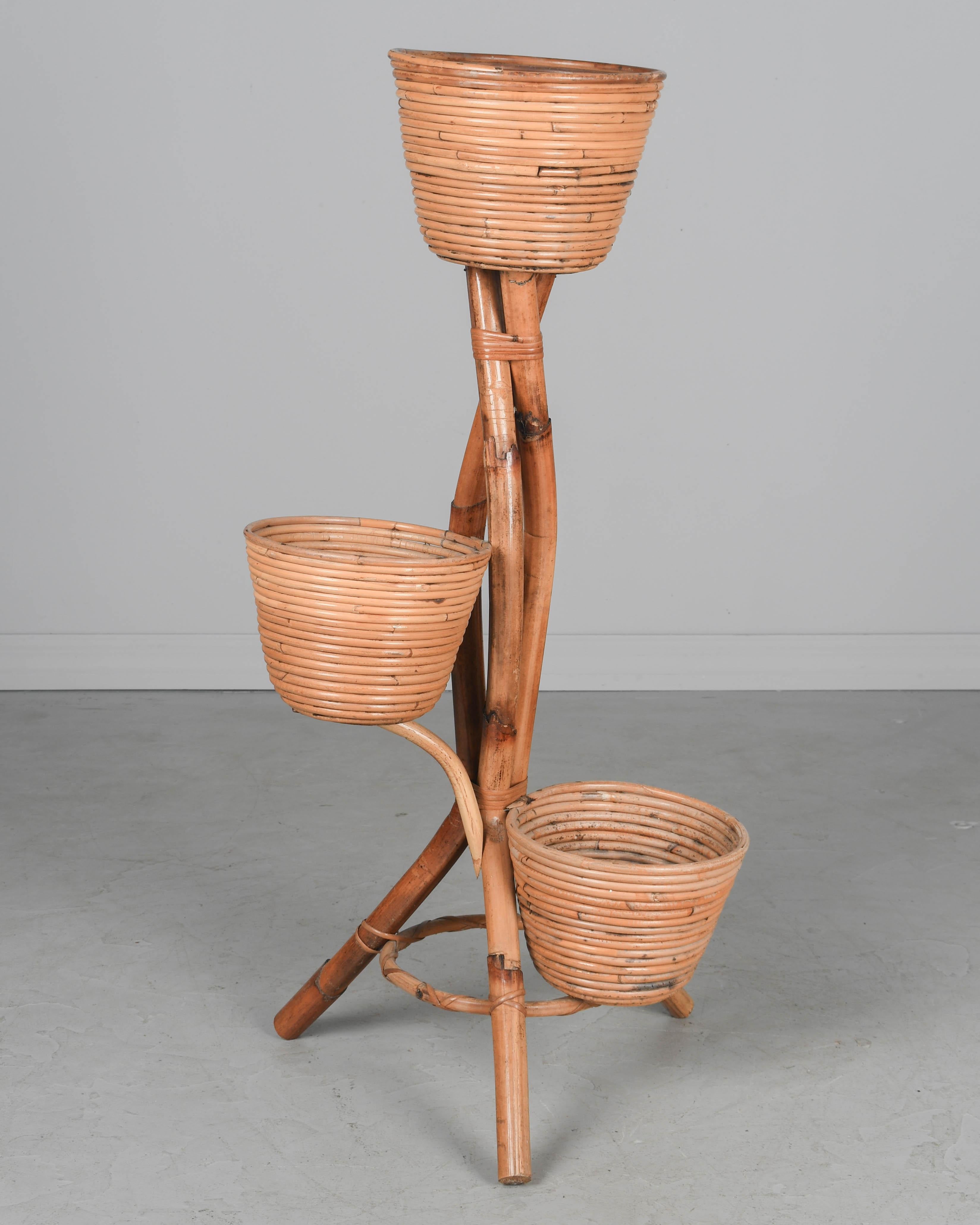 A Mid Century French bamboo plant or flower stand with three pots made of coiled rattan and wood. Sturdy and in good condition. Perfect for the display of orchids or ferns. Circa 1950s
Dimensions: 36
