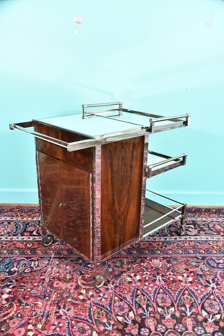 Midcentury French bar cart done by Jacques Adnet
Bar cart is done with nickel-plated brass, mirror, glass and mahogany. It has 2 removable trays, ice storage compartment and storage for bottles and glasses.
An icon of luxurious French modernism,