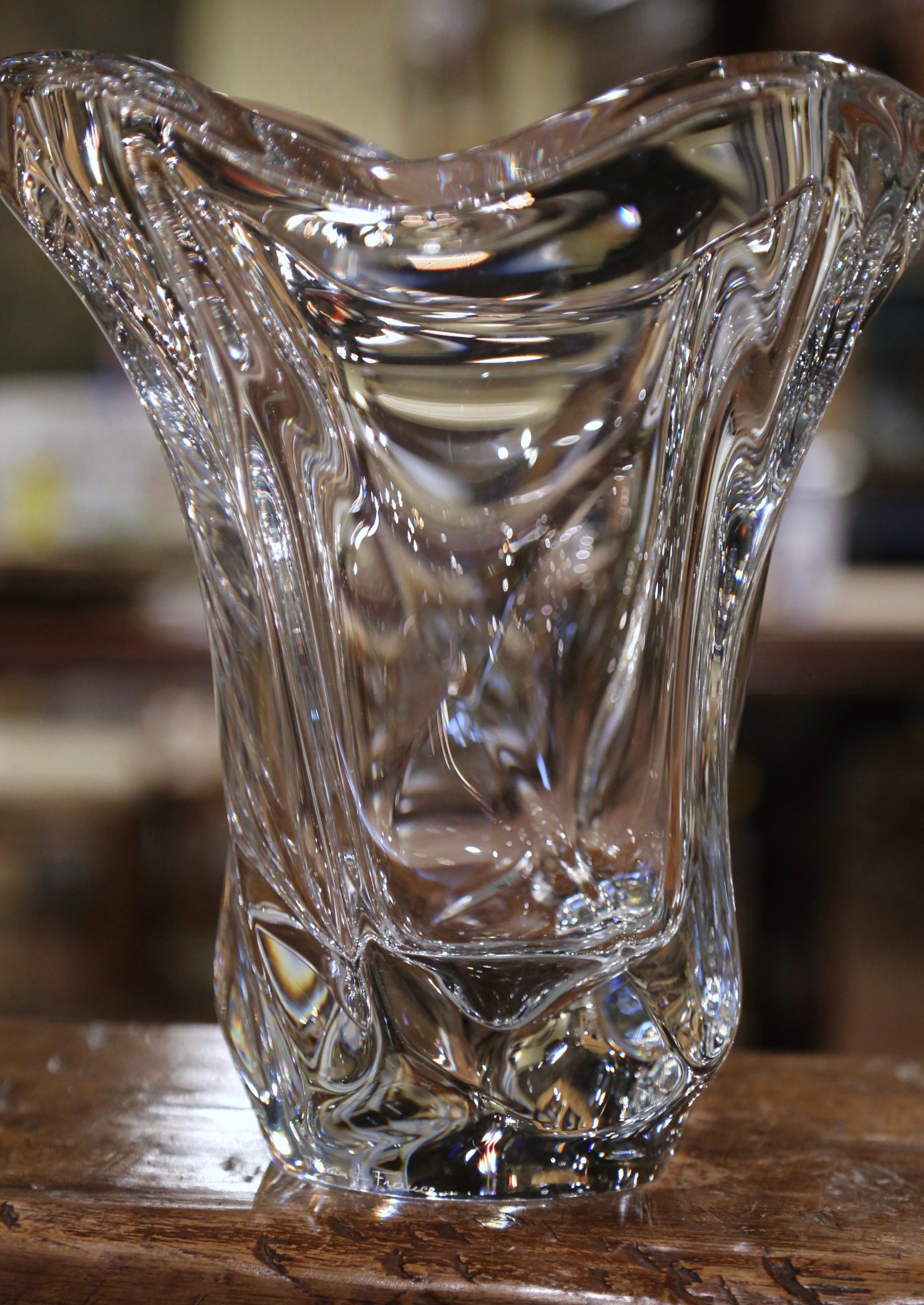 This elegant, hand blown crystal art vase was crafted in France, circa 1950. The large antique piece features a pulled feathered technique with an intricate elongated design and scalloped rim. The large decorative flower recipient is in excellent