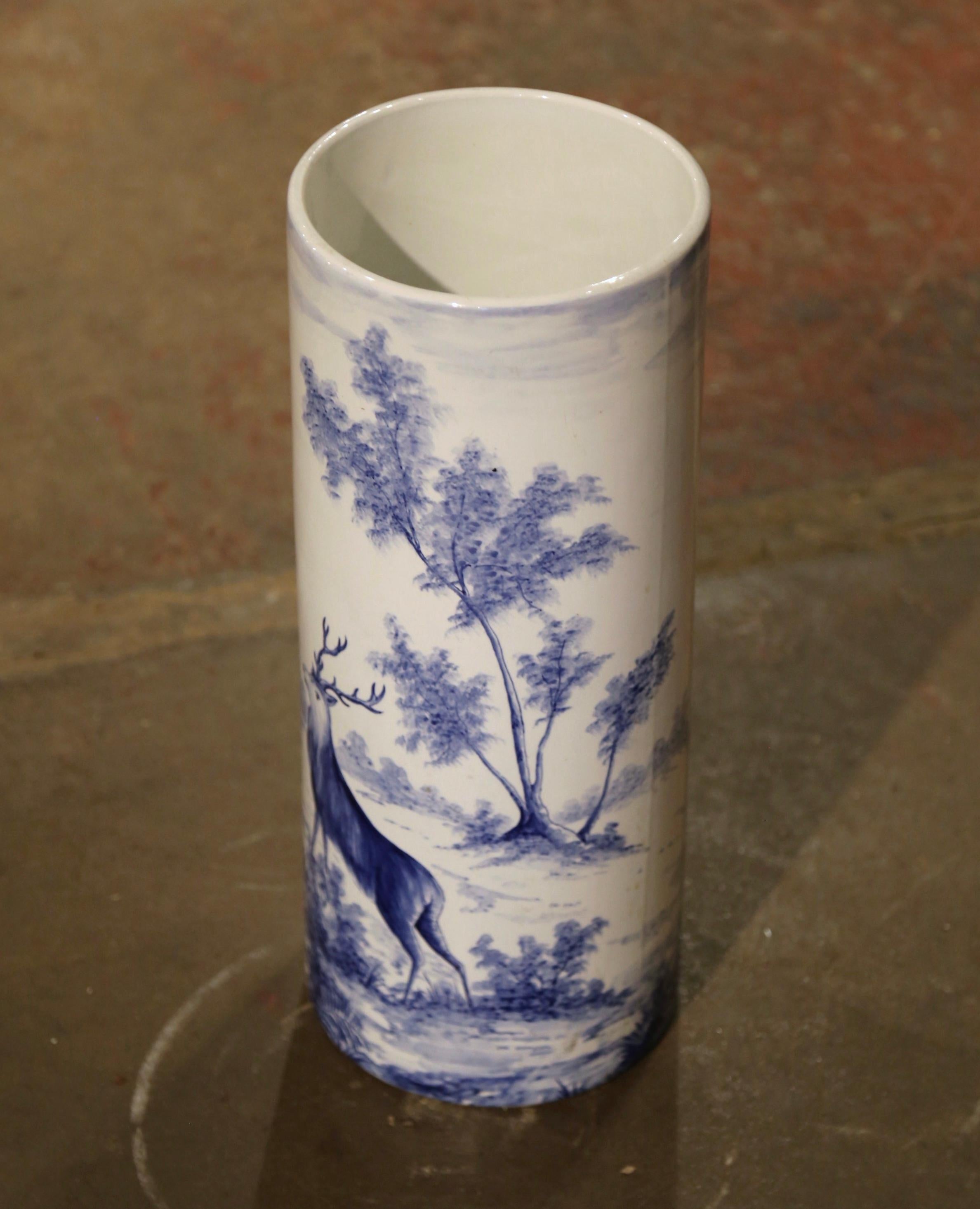 Place this tall, elegant stand at your front door or in your mudroom to catch loose canes and umbrellas. Crafted in France, circa 1950 by the Faiencerie d'Onnaing, the circular porcelain umbrella holder features colorful hand painted pastoral scenes