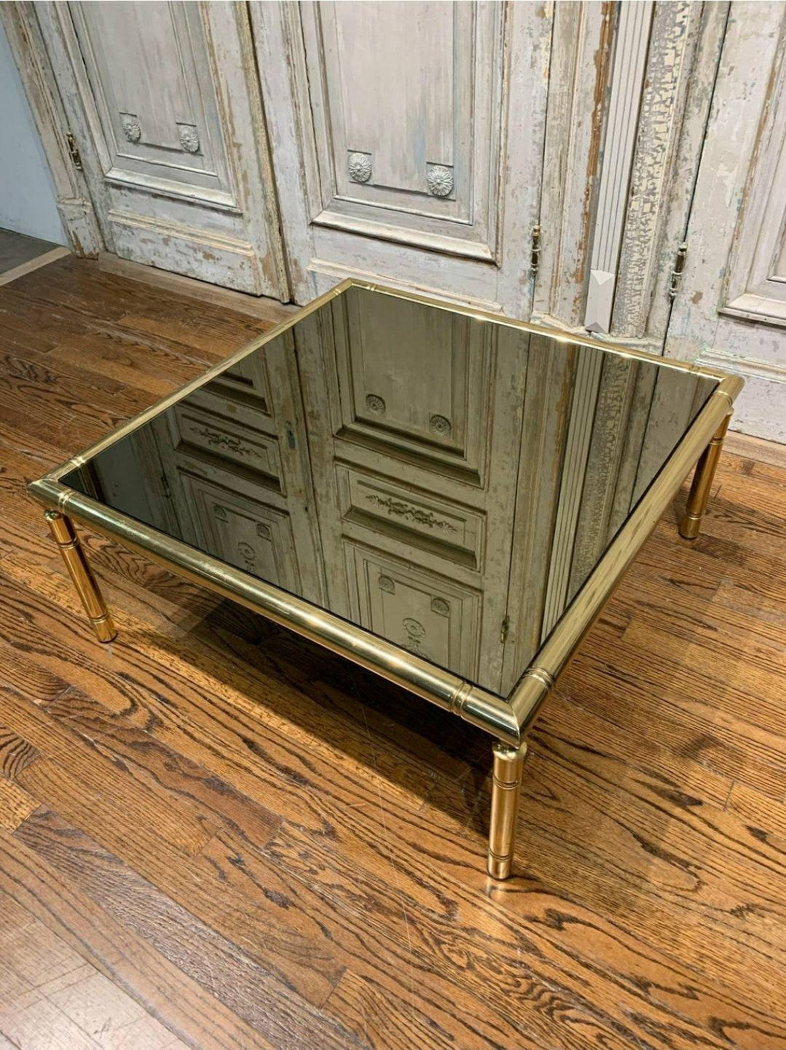 A large, square, French tubular polished brass table, circa 1960s/1970s. The vintage mid-century table has a base frame with a modern faux bamboo-like design, and inset smoked mirror glass top. Substantial proportions, well made, good quality and