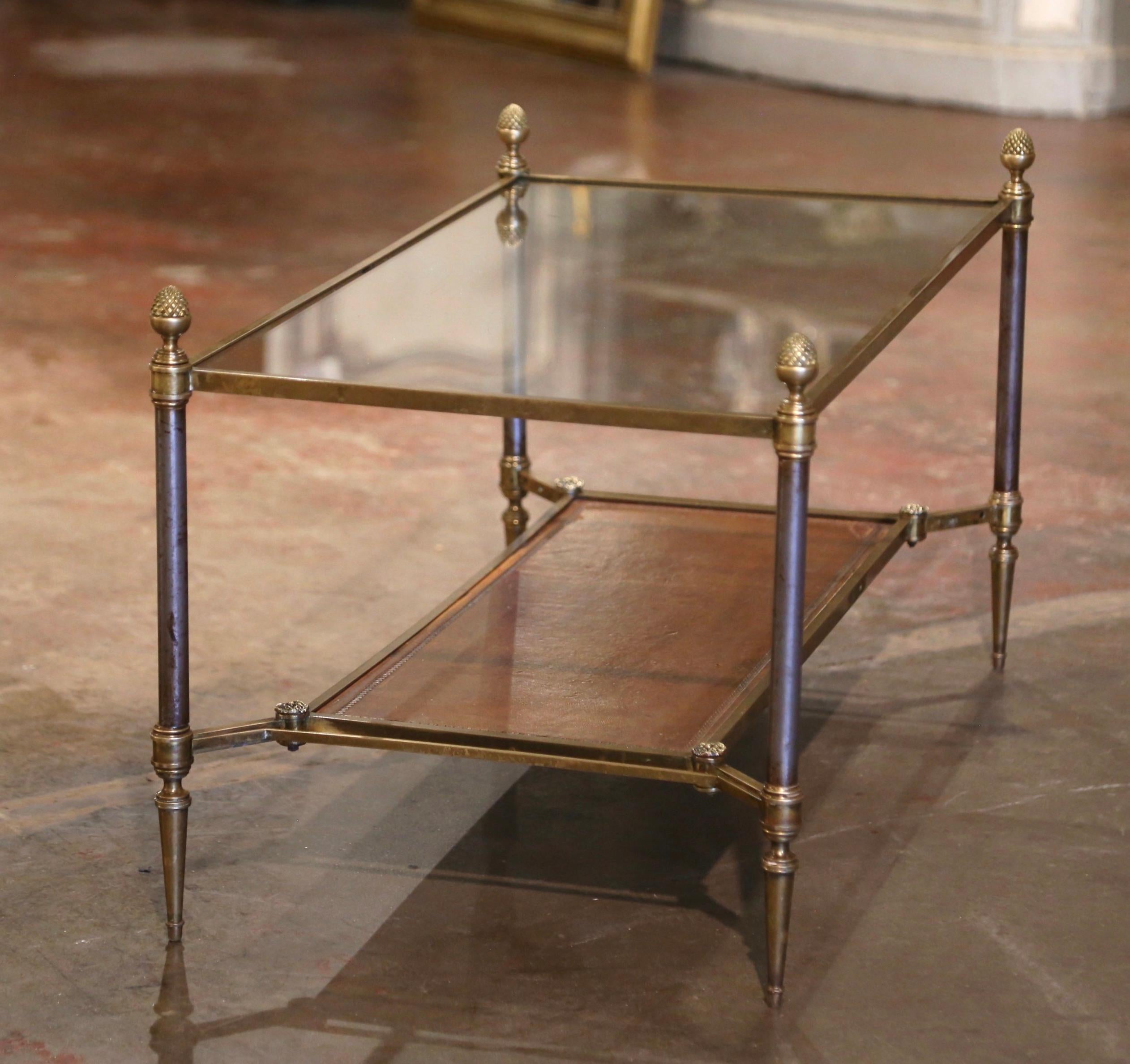 Decorate a living room or den with this elegant antique coffee table. Created in Paris, France, circa 1950 by Maison Jansen, the clean line frame is made of brushed steel, bronze and brass; it features round legs ending with tapered feet, and is