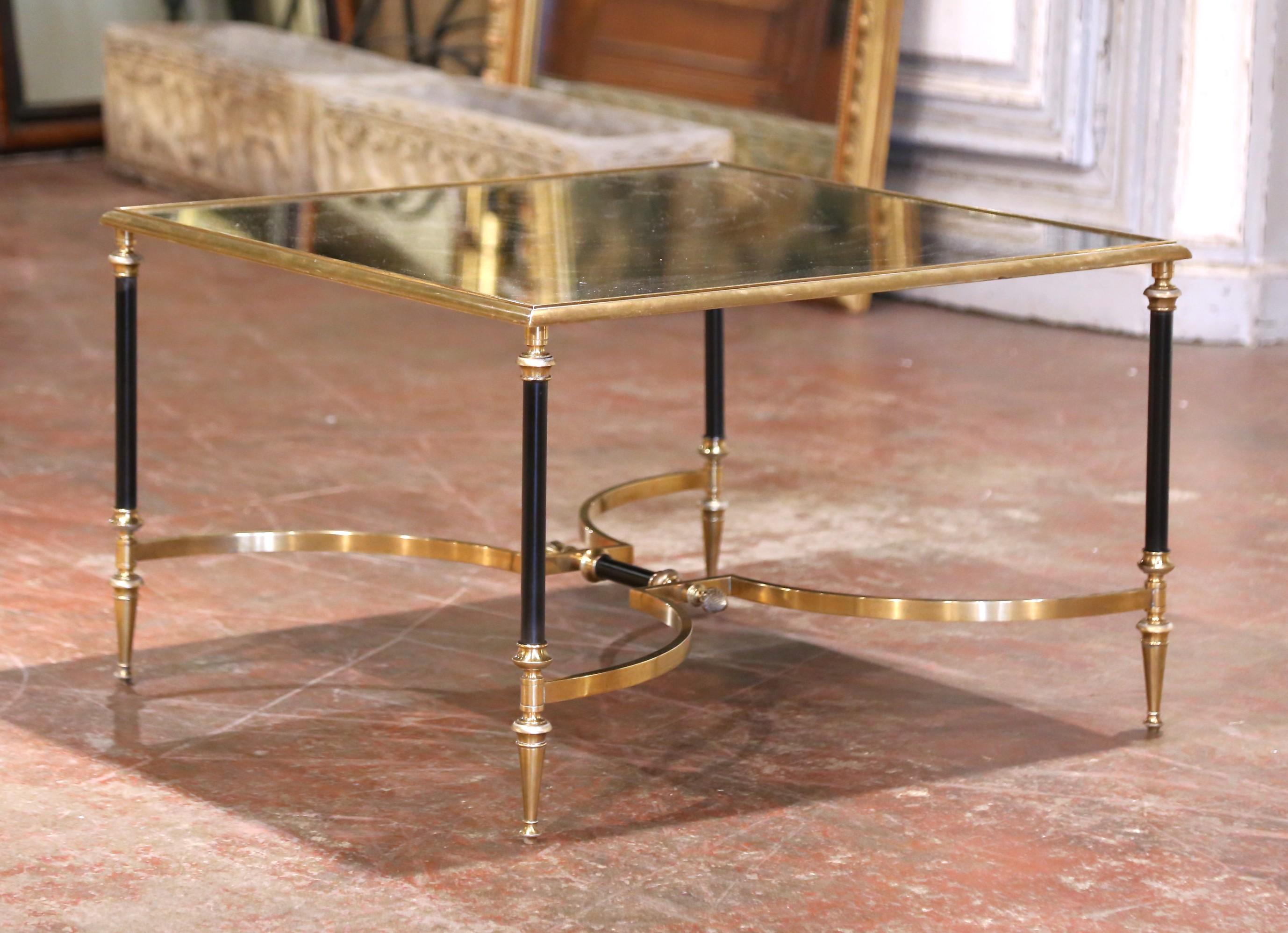 Realizzato in Francia intorno al 1950, questo tavolino di metà secolo della Maison Jansen mette in mostra la celebre fusione di dettagli neoclassici e moderazione moderna dell'azienda. La struttura quadrata presenta un piano in vetro specchiato con