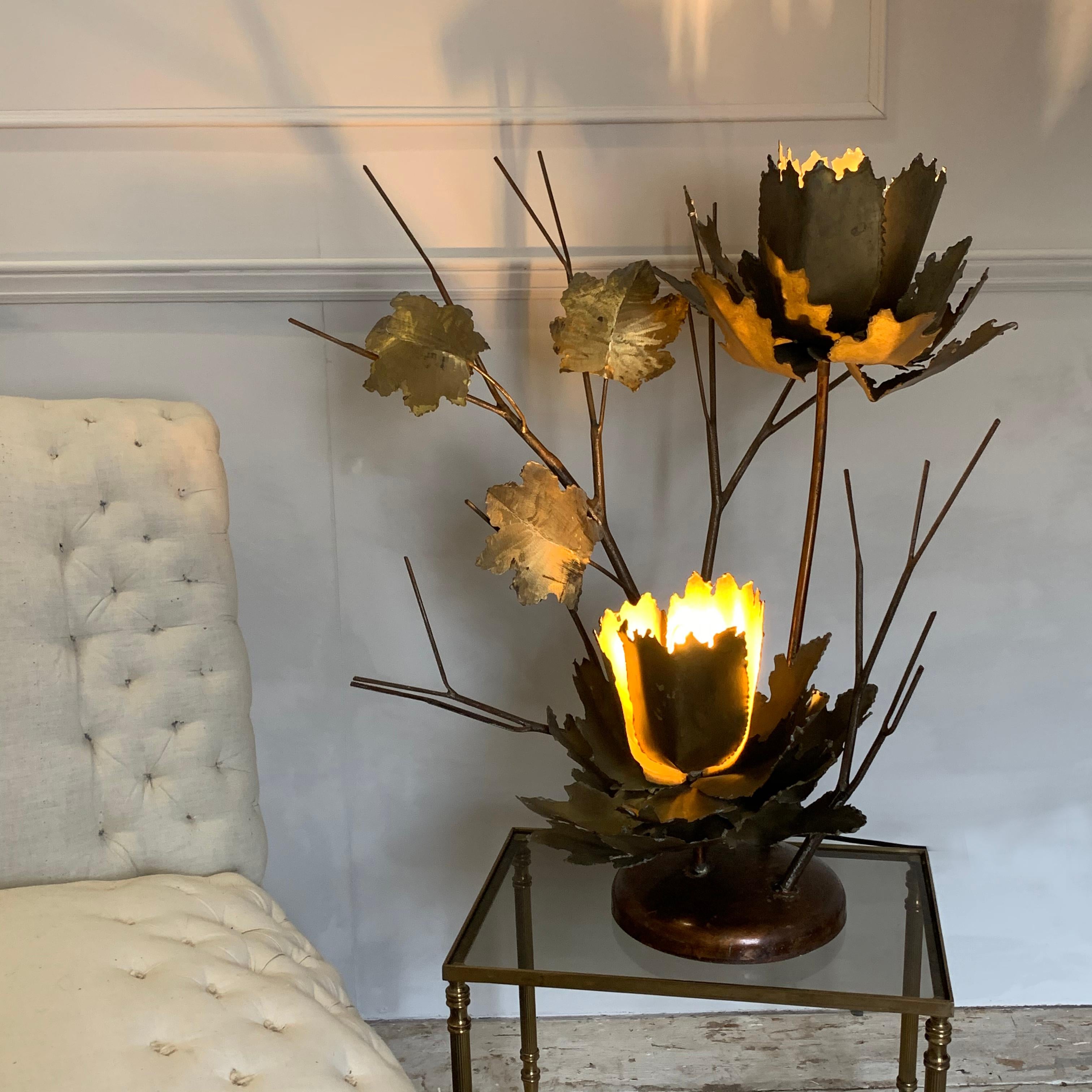 Mid Century French Brutalist flower table lamp,
circa 1960s-1970s
This beautiful large lamp is handcrafted lovingly by an artisan
The large flowers and leaves are in brass with steel twig branches in steel painted with a copper color to match the