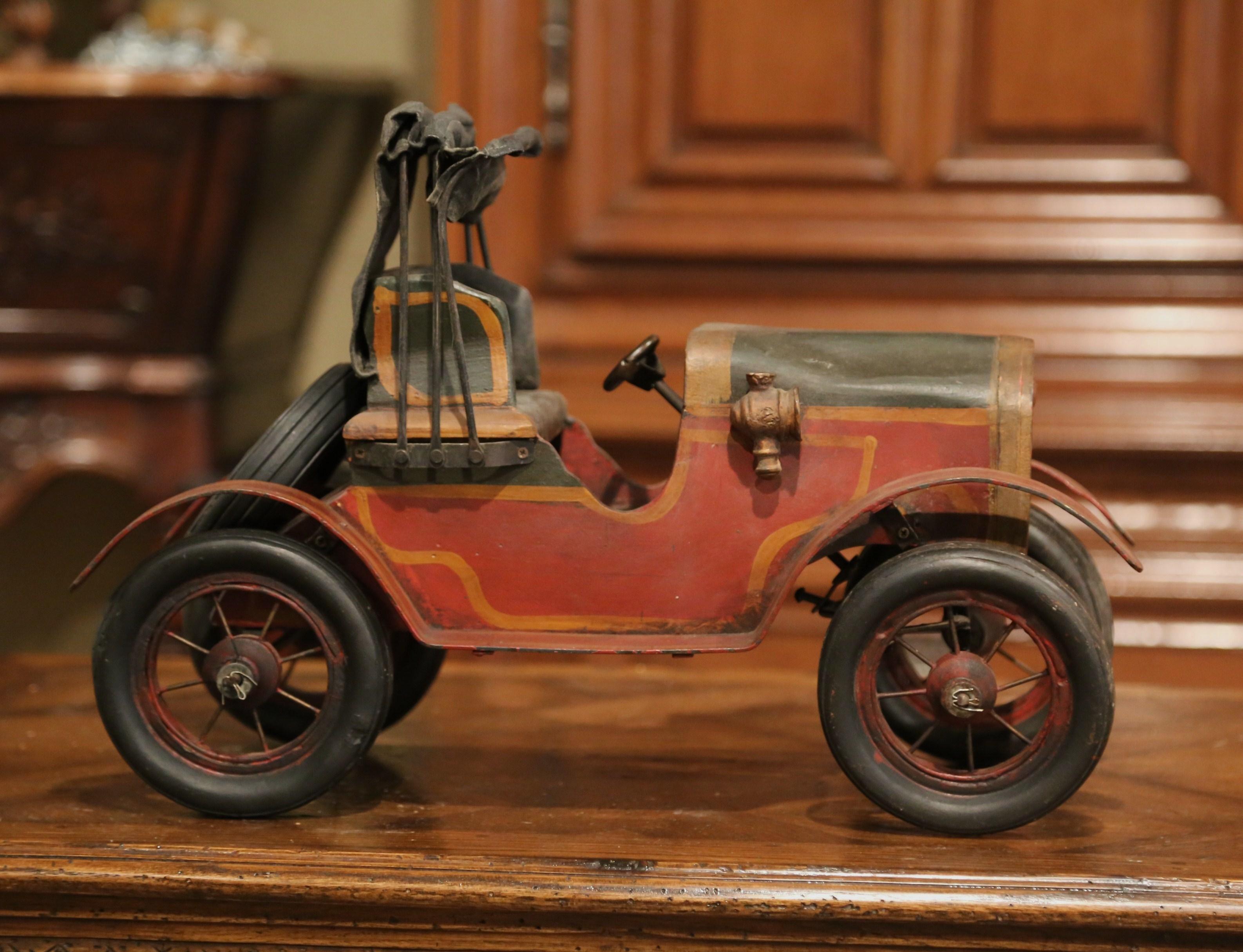 Decorate a man's office or a little boy's room with this vintage model car. Crafted in France, circa 1970, the Classic, miniature car stands on rubber tires with a spare wheel attached on the back. The piece is a must-have for the car collector. The