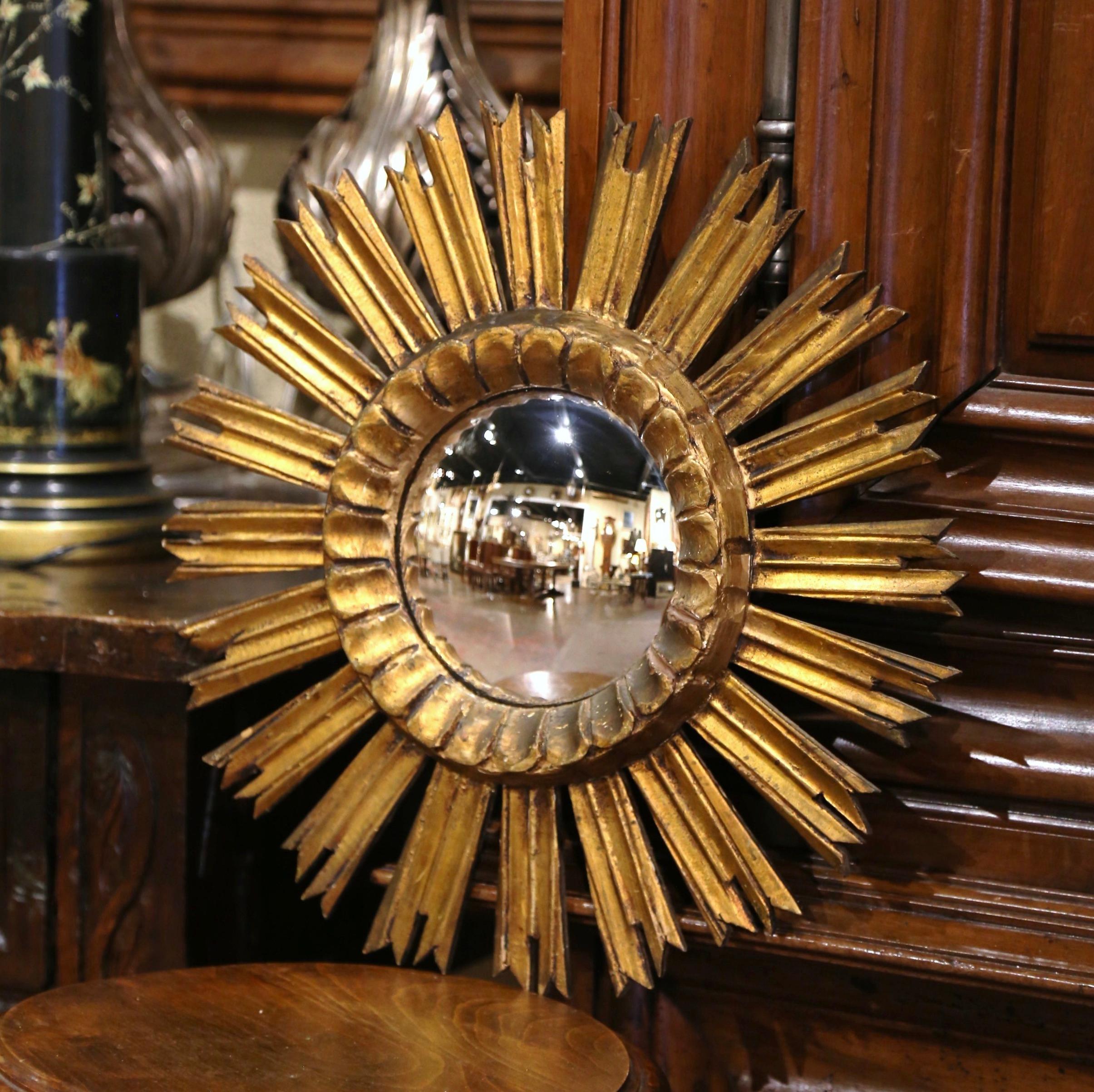 Add a beautiful shine to your home with this eye-catching gilt wood sun mirror. Hand carved in France circa 1990, the vintage mirror features a convex, circular center, which is surrounded by a series of radiating, gilded rays, a design element that