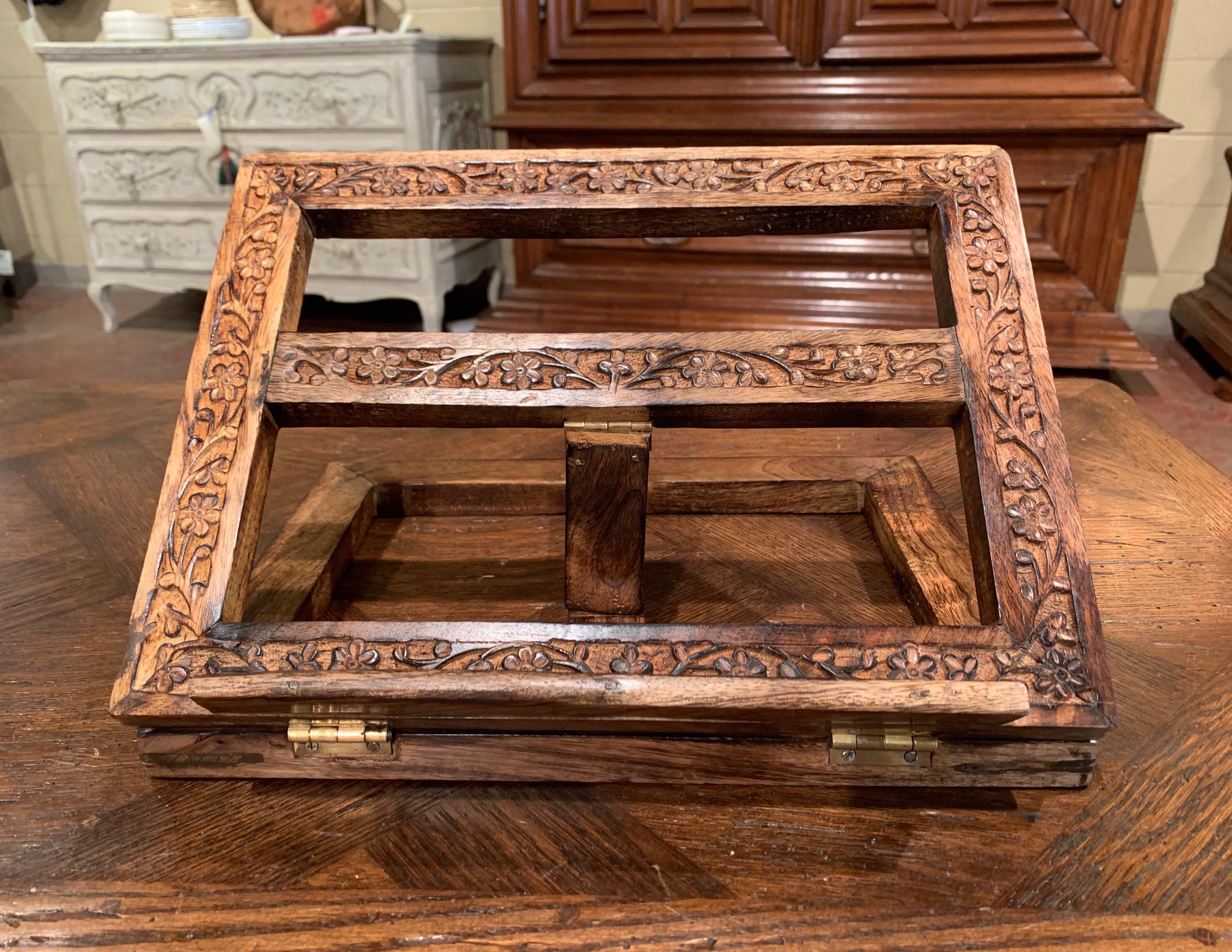Place a cookbook on this antique stand for easy meal prep in the kitchen! Created in France, circa 1950, the Classic table stand sits on a rectangular base and has a pitched book holder back with variable grades; it is decorated with hand carved