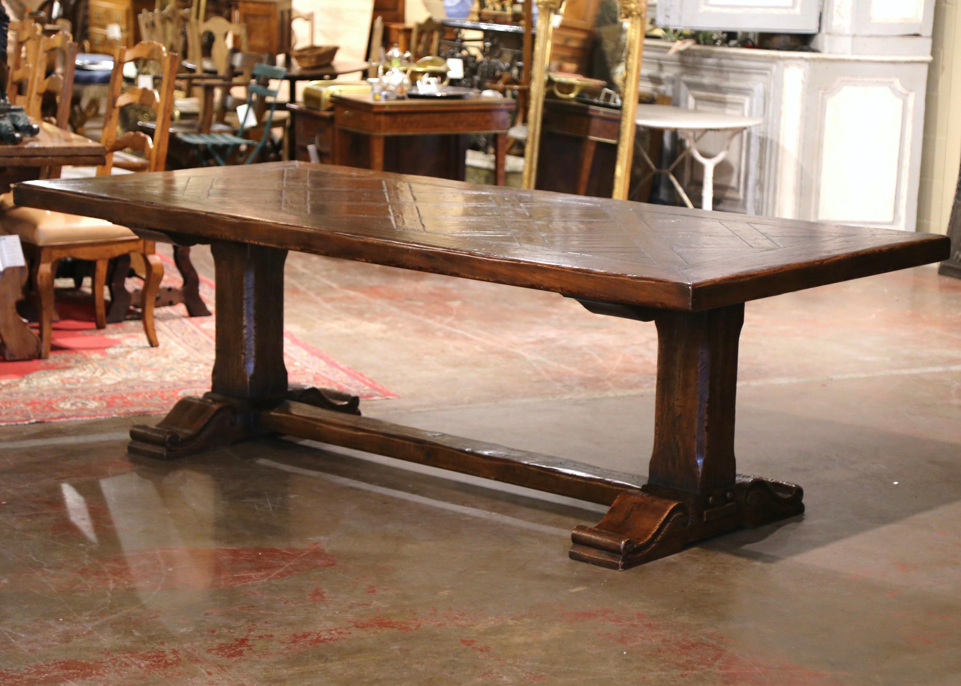 This large 8 feet long fruitwood dining table was crafted in southwest France, near the Spanish and French border circa 1970. Built with antique and reclaimed old timbers of different species, the heavy table stands on a trestle base, supported with