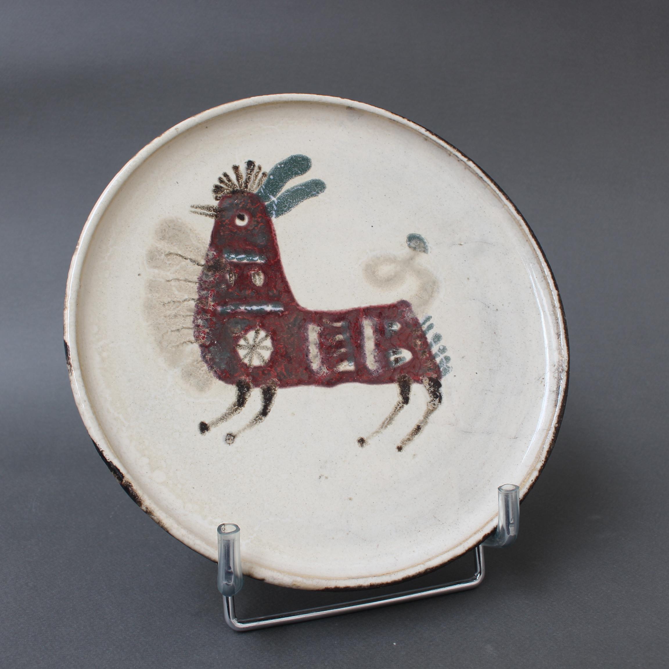Mid-century French ceramic decorative plate by Le Mûrier (circa 1960s). A seductive piece with their signature style, chalk-white colour base with stylised imaginary animal motif. In good overall condition. Maker's mark on the underside, Le Mûrier's