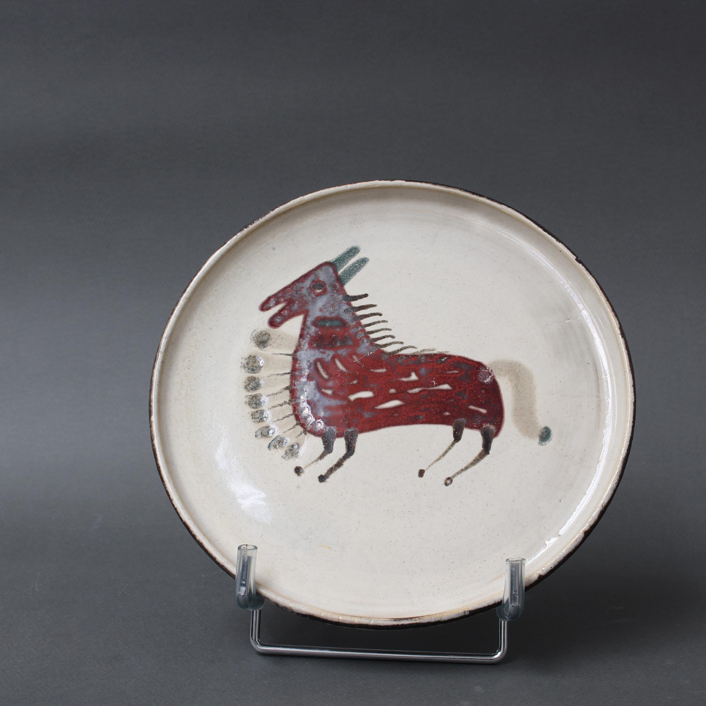 Mid-century French ceramic decorative plate by Le Mûrier (circa 1960s). A seductive piece with their signature style, chalk-white colour base with stylised horse motif. In good overall condition. Maker's mark on the underside, Le Mûrier's trademark
