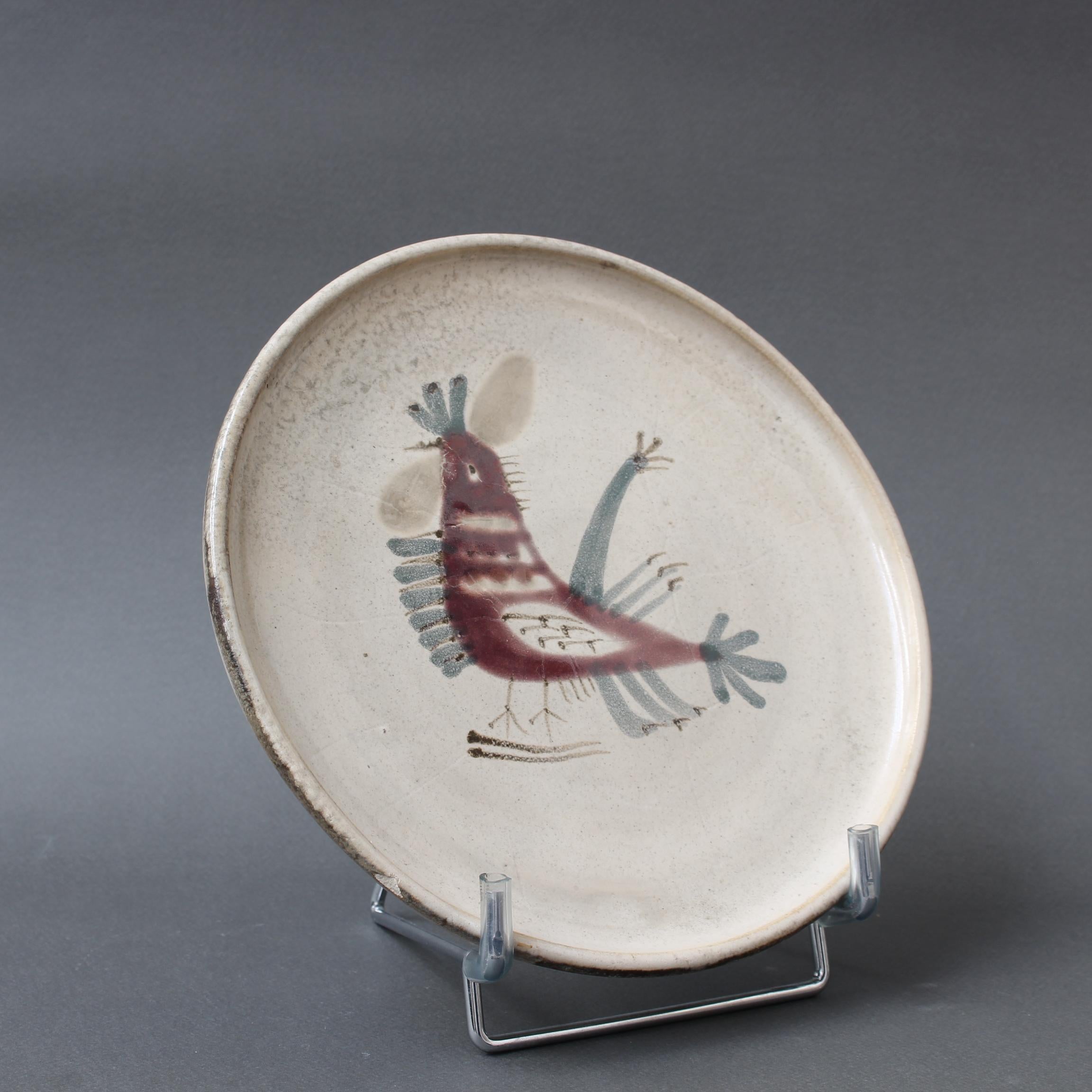 Mid-century French ceramic decorative plate by Le Mûrier (circa 1960s). A seductive piece with their signature style, chalk-white colour base with stylised French coq motif. In fair overall condition with a small chip on the rim (circled in photo).