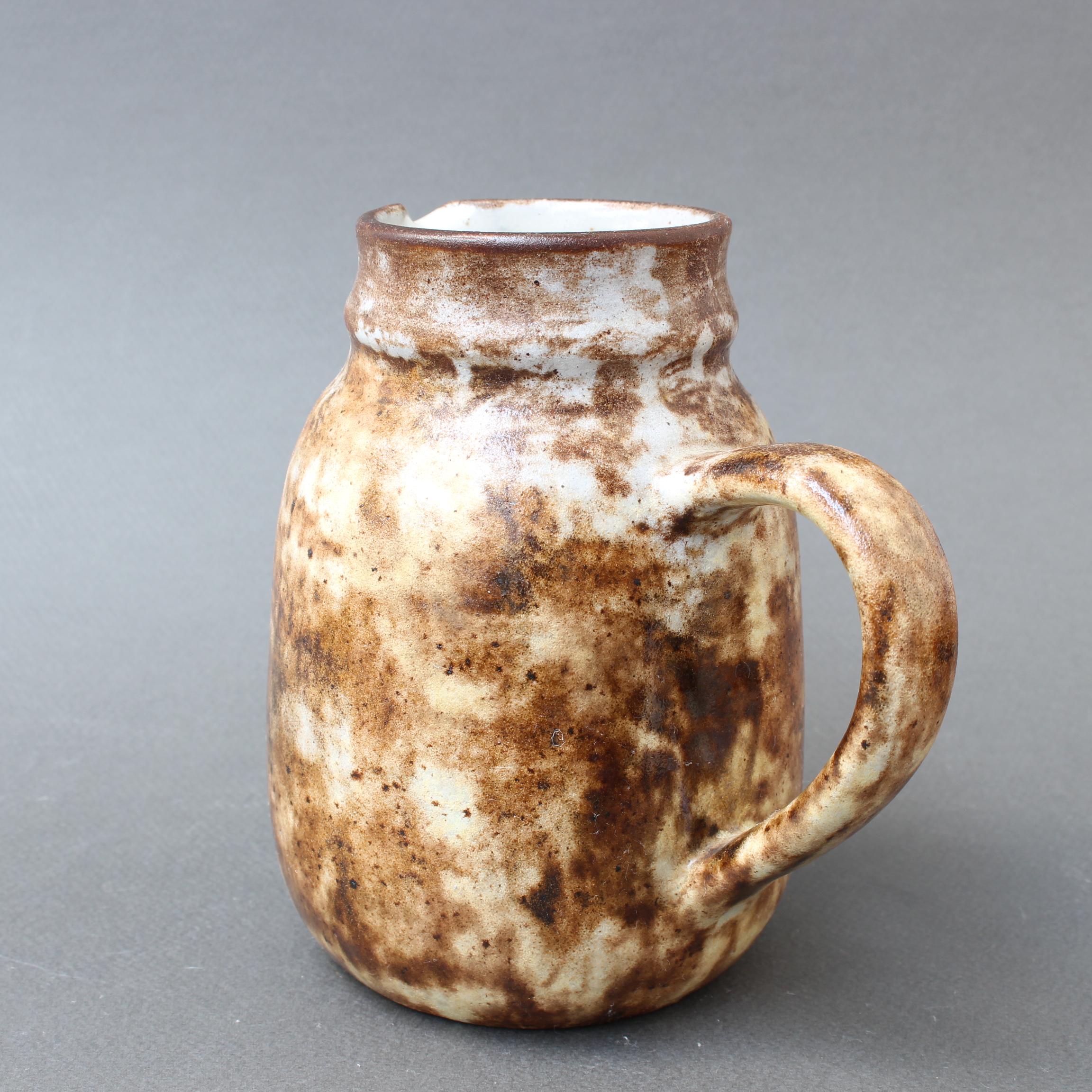 Midcentury ceramic jug / vase by Alexandre Kostanda (circa 1960s). In his trademark natural clay and rustic style, Kostanda created beautifully original vessels, such as vases, pitchers and pots which were both utilitarian and stunning works of art.