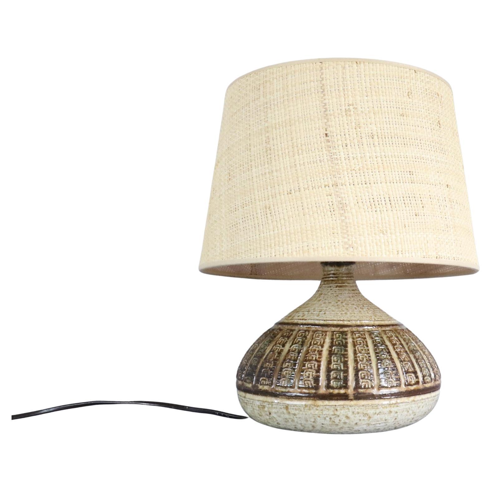 Midcentury French ceramic lamp by Marcel Giraud - Vallauris - 1960s.

It is a beautiful handcrafted table lamp both raw and elegant that can blend either in a country chic atmosphere or in a refined interior.
Enamaled and decorated with