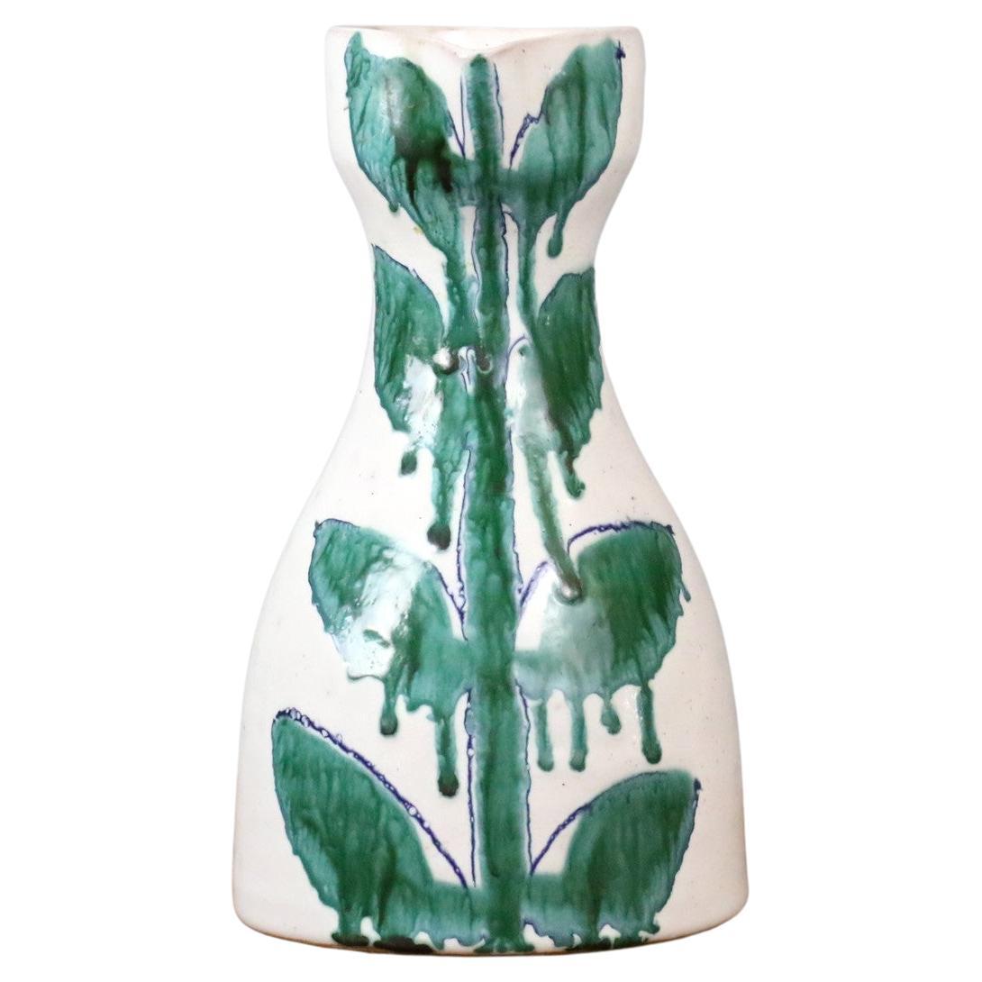Mid-century French Ceramic Pitcher by Naumovitch - Grand Chêne Studio, Vallauris
Pitcher with a bright white background, it is glazed and decorated in an original way with leaf motifs and an aesthetic play of drips. 
The pitcher is in very good