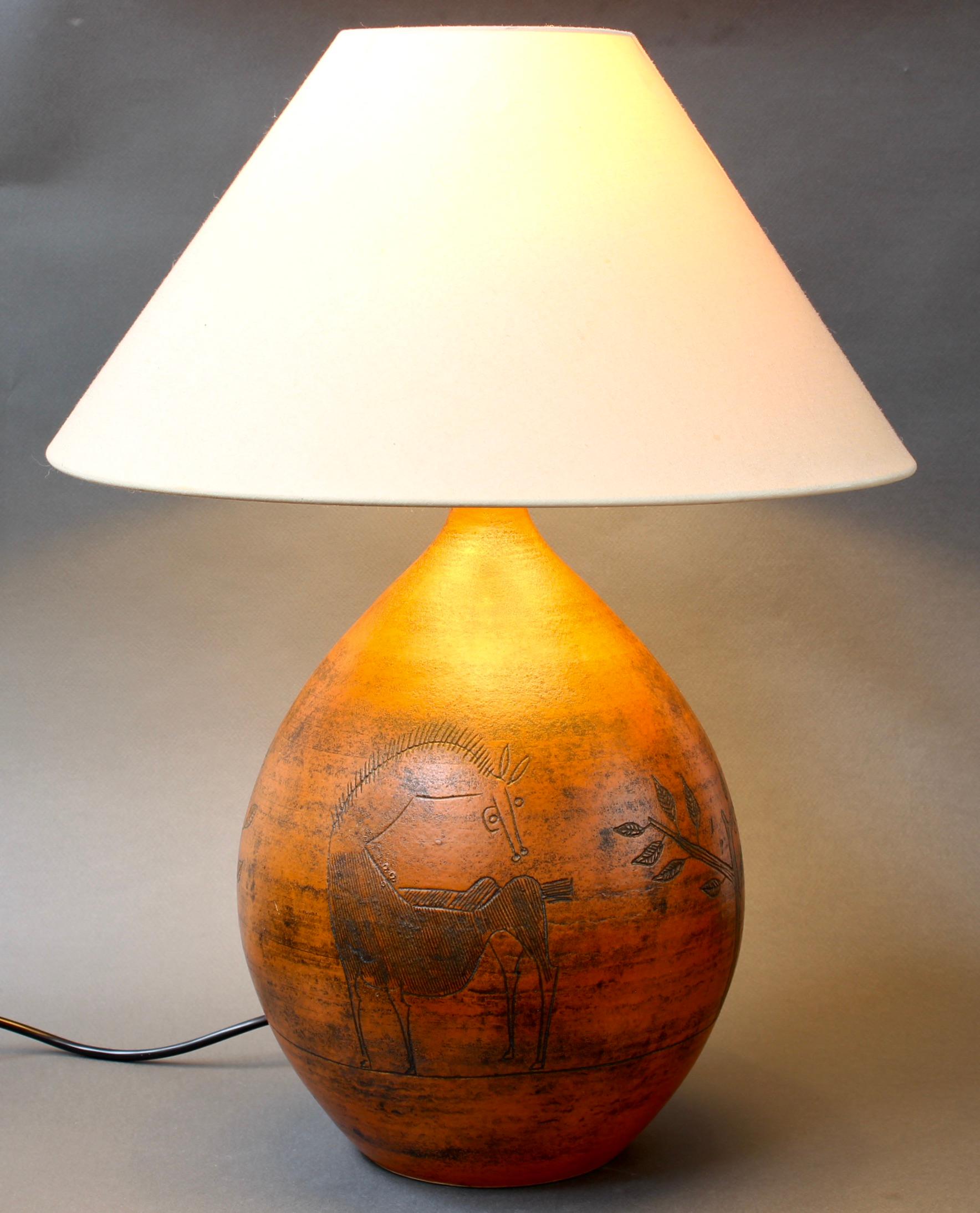 Large vintage ceramic table lamp (circa 1950s) by French ceramicist, Jacques Blin. This stunningly beautiful rust-coloured French lamp incorporates Blin's characteristic sgraffito-etchings on its surface. They include fantastical animals and plant