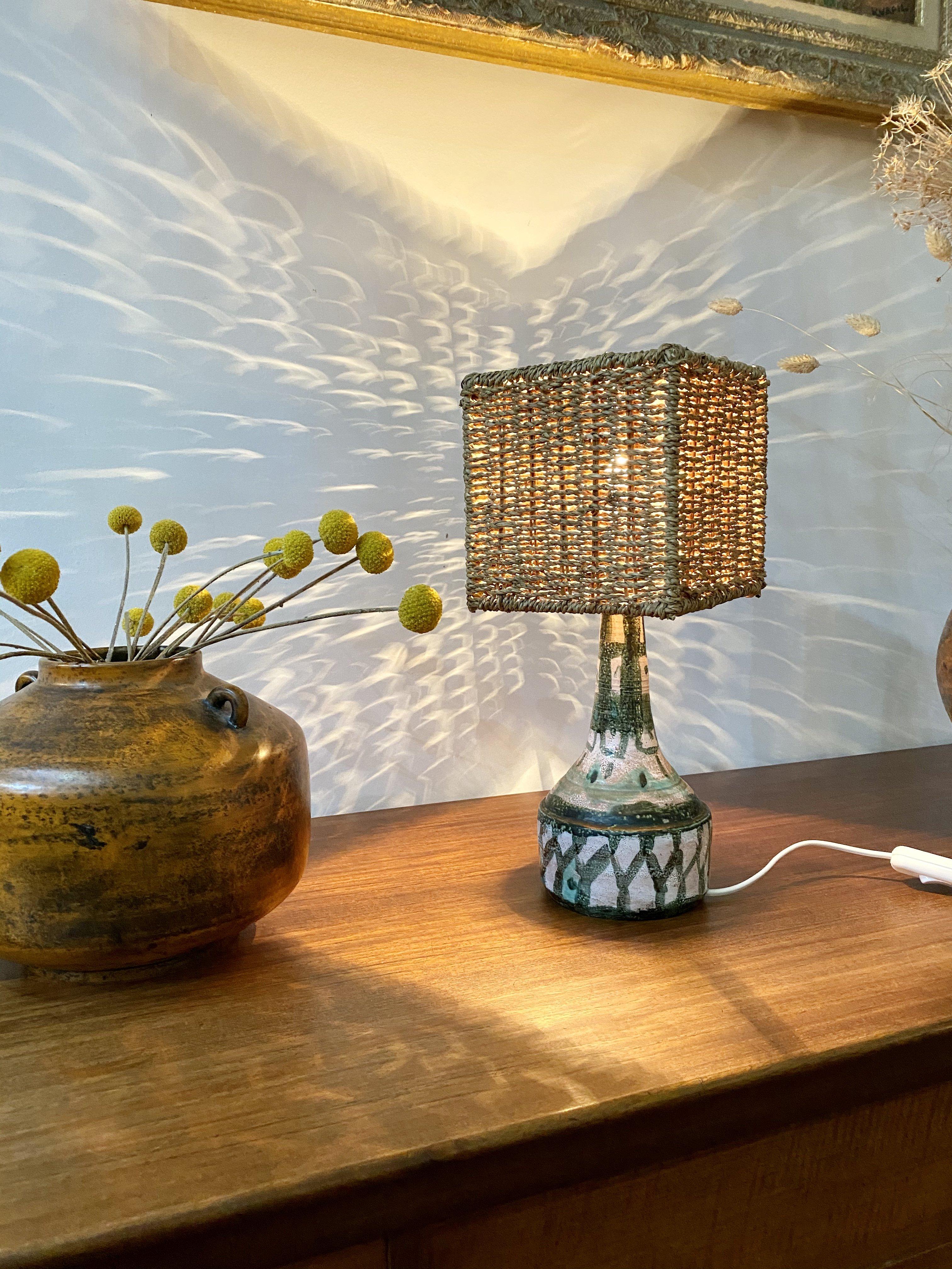 Midcentury French ceramic table lamp with shade, (circa 1960s). Similar in style to ceramicist, Albert Thiry, this table lamp meets midway between Morocco and the South of France. It has charm, elegance and personality all at once. Regrettably,