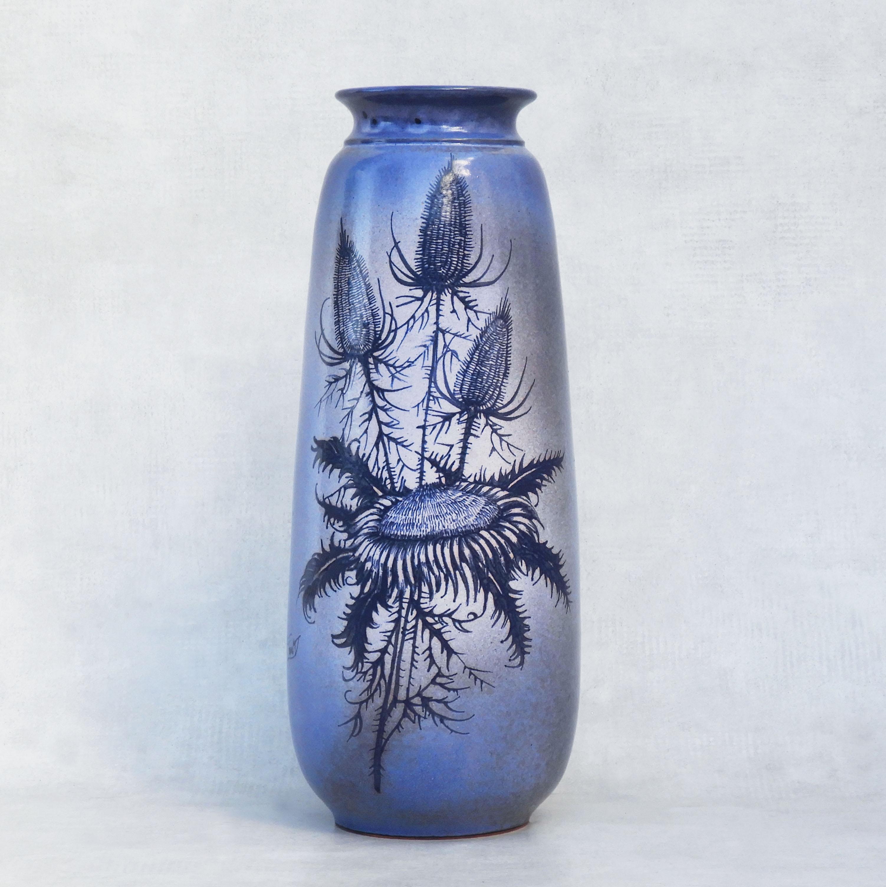 Mid-century Vallauris Vase by Jacques Fonck et Jean Mateo C1960s France

A tall attractive vase, in blue glaze with purple hues, beautifully hand-painted with an autumn bouquet of a sunflower and thistles (Les Chardons et le Tournesol).

A