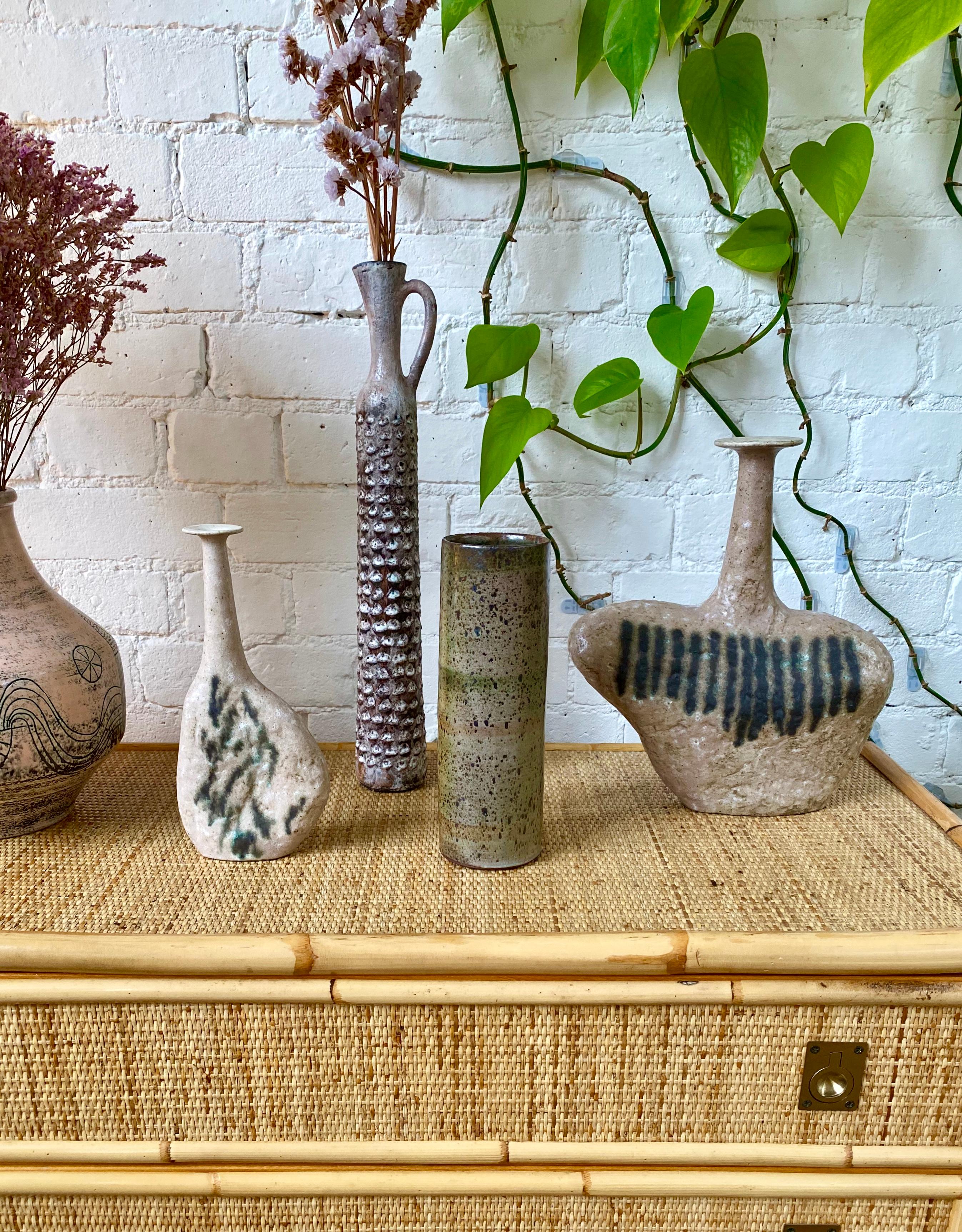 Midcentury French ceramic vase (circa 1960s) by Jacques Pouchain - Atelier Dieulefit. An elegant vase in cylindrical form is enveloped in a sumptuous glaze on both the exterior and interior. The speckles in the glaze are reminiscent of beautiful