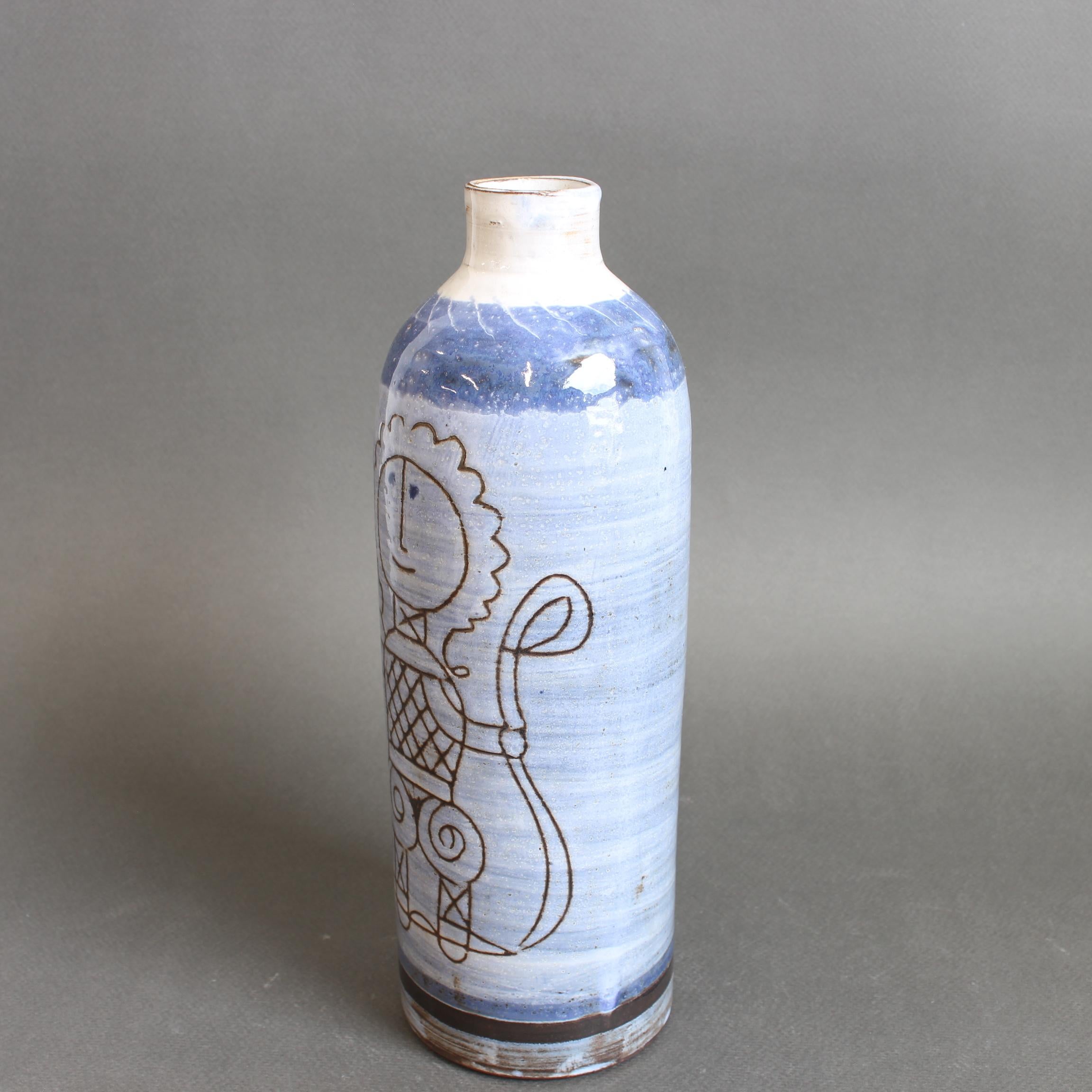 Un élégant vase cylindrique en céramique datant des années 1960 de Michel Barbier. La forme est raffinée, avec une lèvre étroite et une glaçure émaillée brillante et lustrée qui enveloppe à la fois le corps et le bord. Le motif central est une