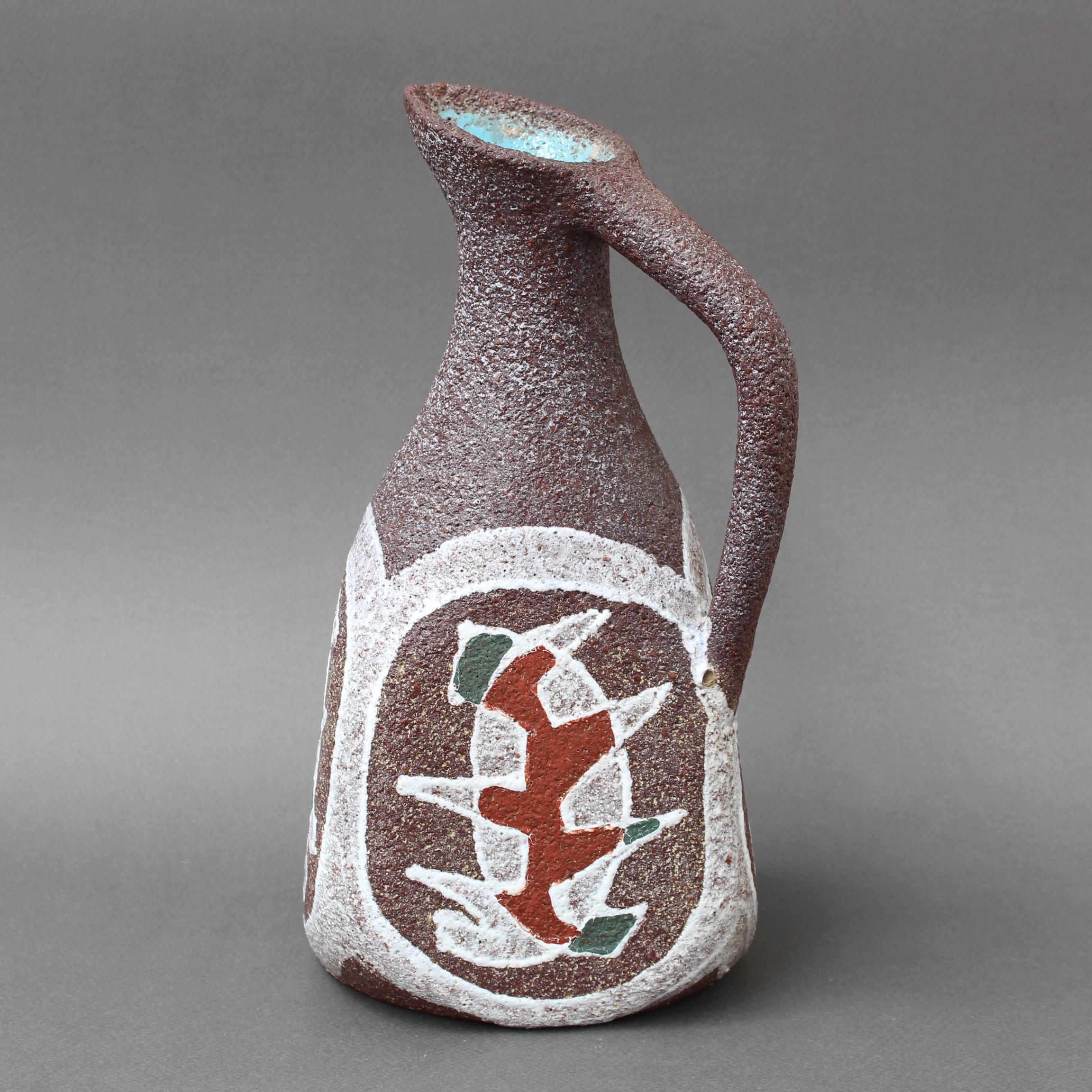 Decorative midcentury ceramic vase / pitcher by Accolay (circa 1960s). A classically shaped piece from antiquity is reinterpreted in Accolay's unmistakable style. The pitcher has soft, sensuous curves and a long, graceful handle. The decoration is