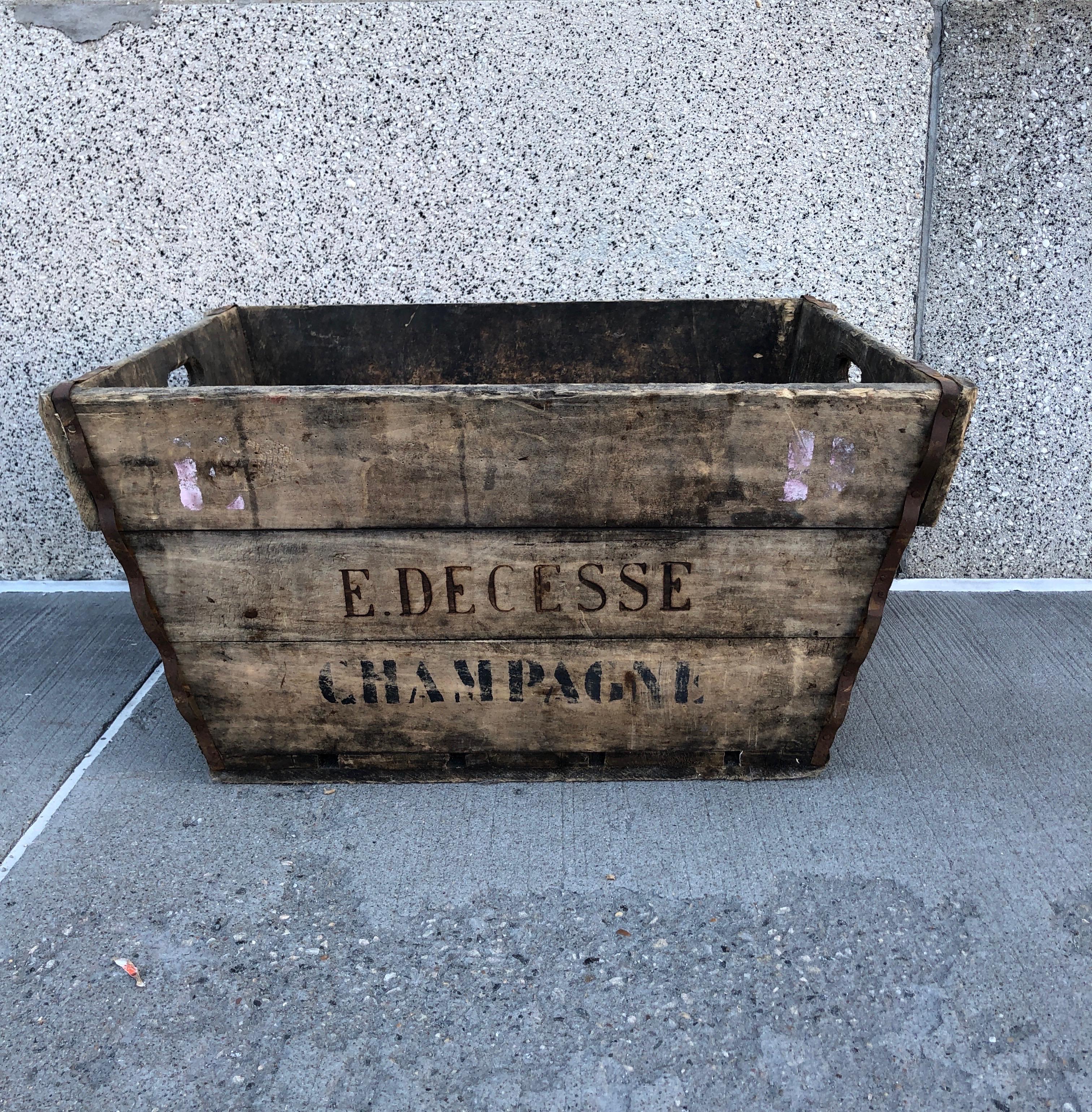 A stunning, beautifully worn wooden vintage champagne harvest basket with stenciled name of vineyard prominently featured on both sides. This sturdy, large wooden box is a natural for firewood, or as an entry way piece to hold shoes, toys, or