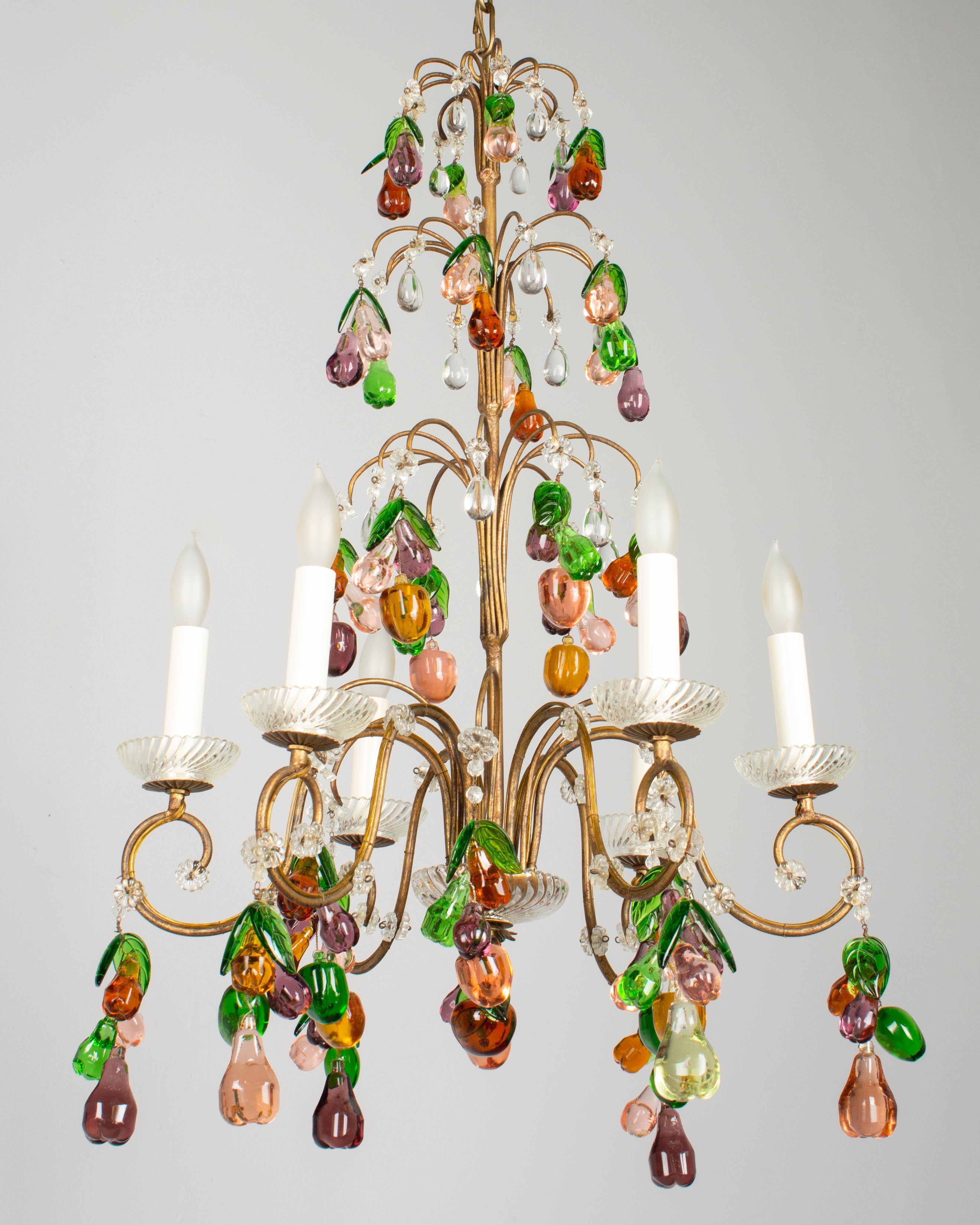 A magnificent, whimsical Italian six-light chandelier with gilded metal tiered frame dripping with colorful glass fruits. All original and completely intact. Large clusters of molded glass pears, apples and plums in amber, purple, and peach with