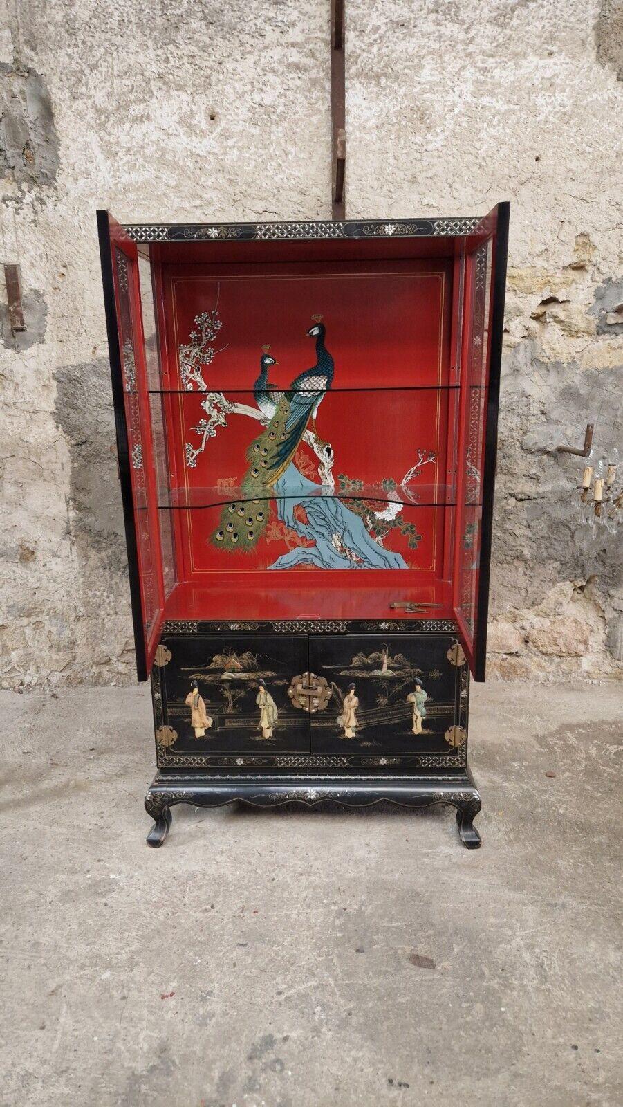 Fabulous Chinoiserie cabinet

Black Lacquered wood
Mother of Pearl Geometric patterns & oriental figures
Red Lacquer to back Panel

Hand painted Peacocks
Brass handles & original padlocks

Glass shelves above

Cupboard below with wooden