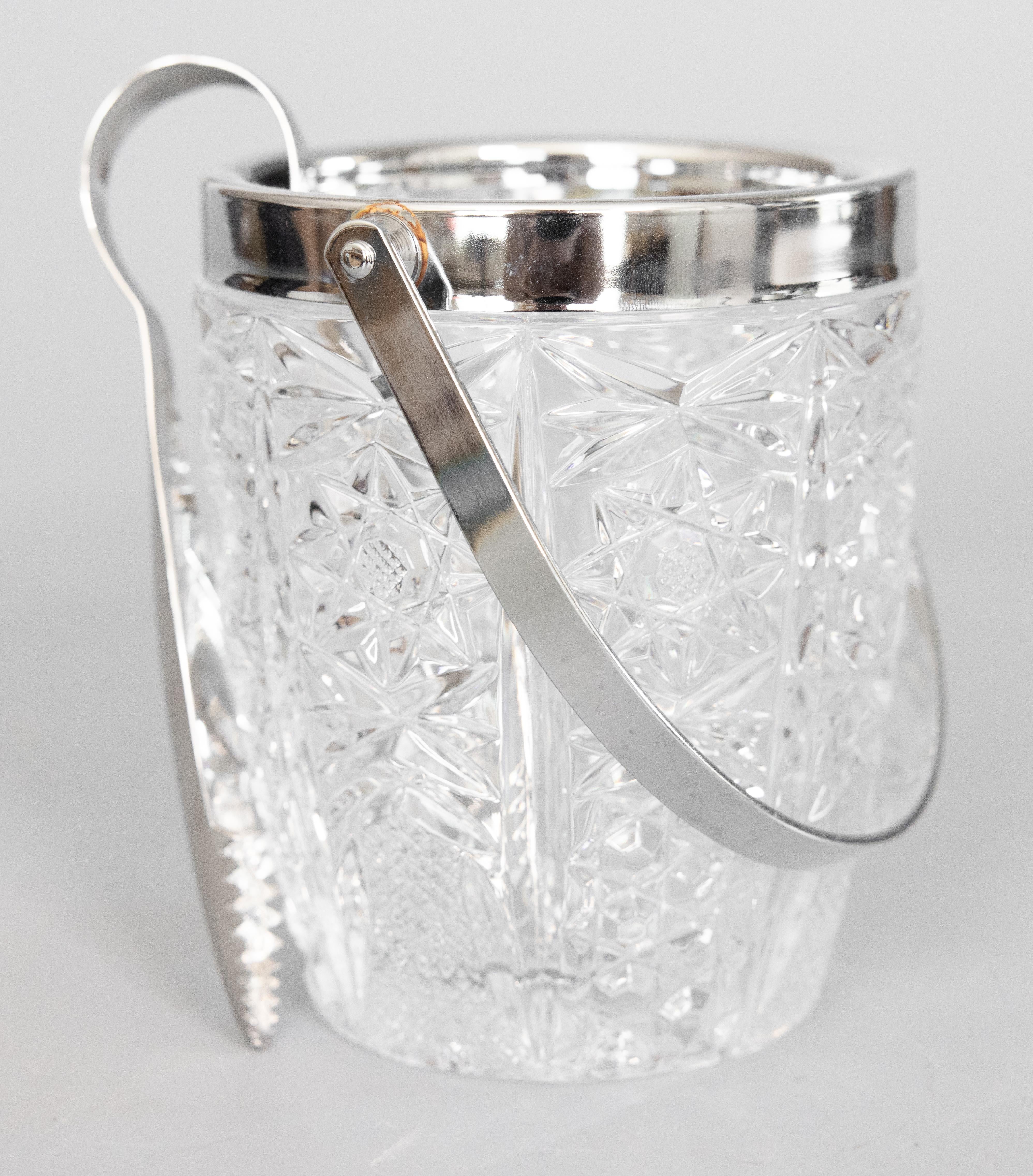 A fabulous Mid-Century French chrome and cut glass ice bucket with tongs. Add this stylish set to your barware collection or for serving at your next party! The height with the handle extended is 9