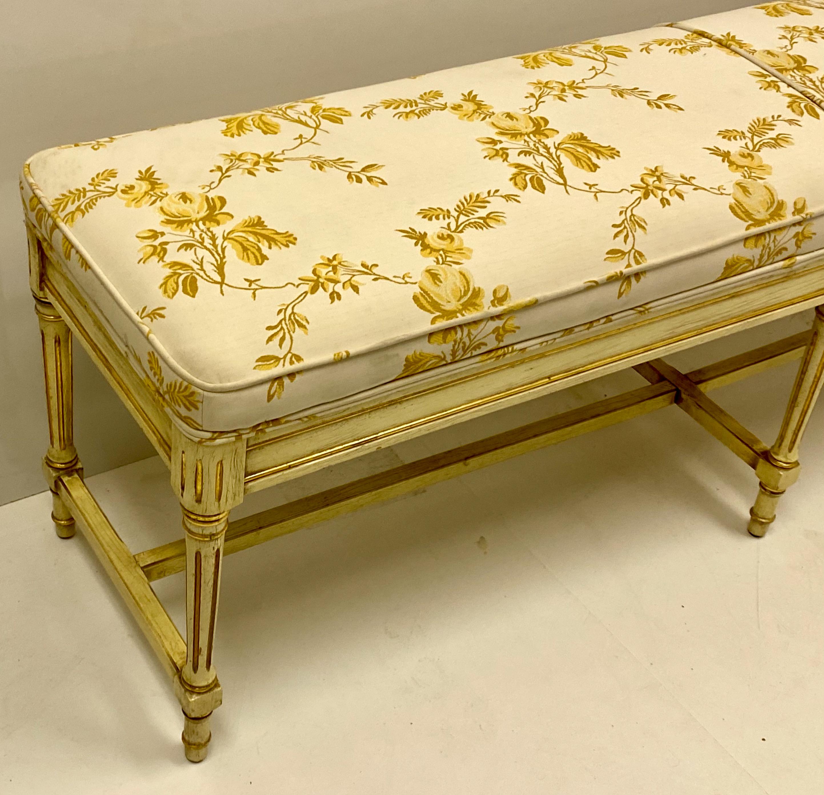This is a midcentury French upholstered bench by Claude Moulin. The fabric is original and shows mild wear. The painted frame is a warm butter ivory. It is marked in two places.