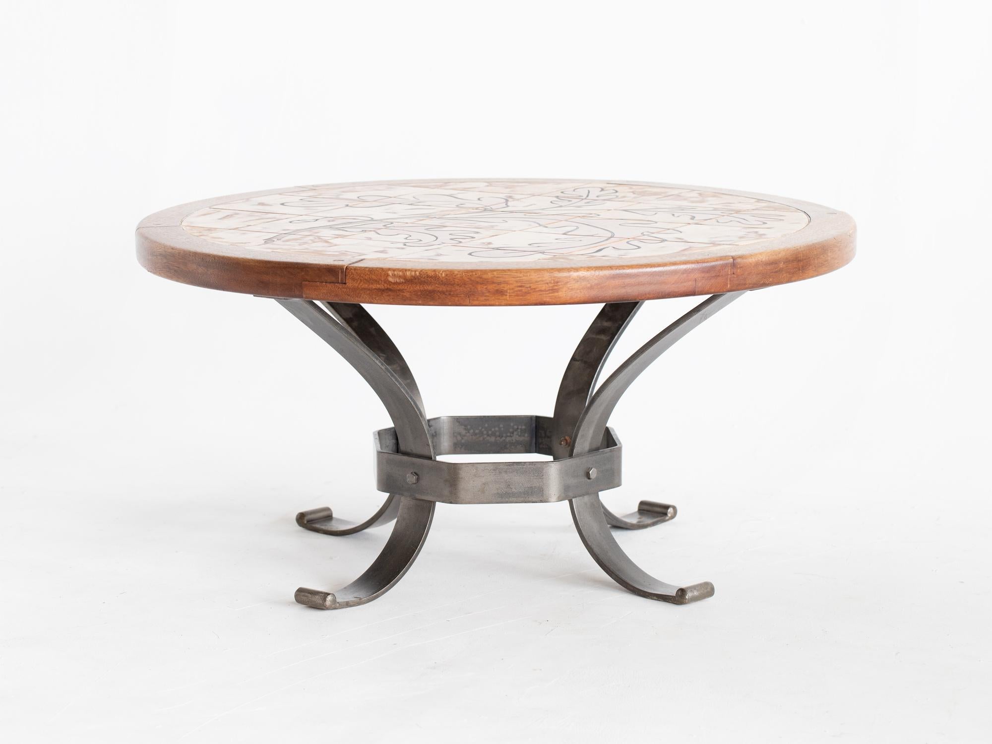 A mid century circular coffee table signed Dutron. French, c. 1970.

The ceramic tile top, depicting an autumnal branch of an oak tree, with walnut border raised on a steel base.

In good sturdy order with undamaged tiles.

42.5 x 87 x 87 cm

16.7 x