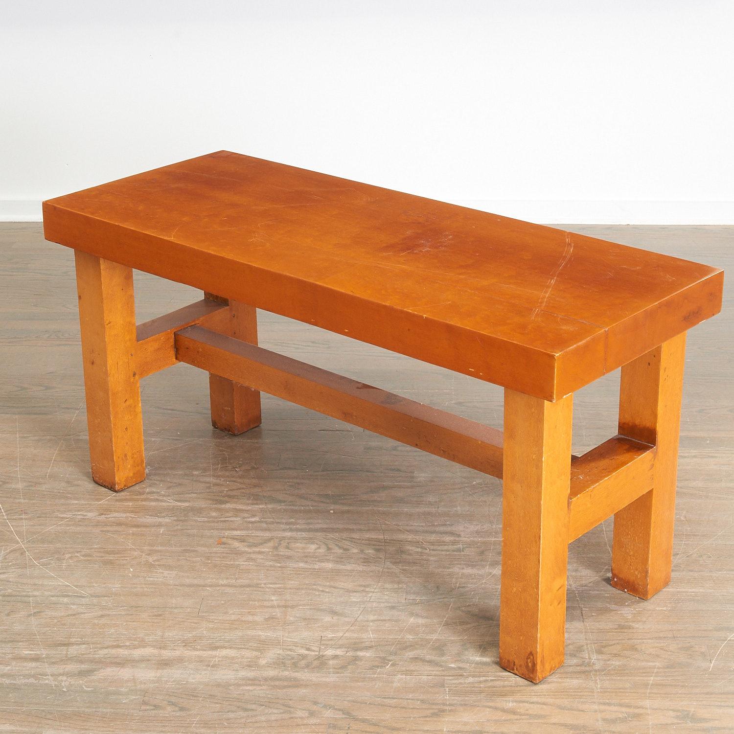 A substantial solid wood coffee table, c. 1940/50s, in the manner of Charlotte Perriand's Les Arcs ski resort décor. A heavy wood (likely elm) slab top on block legs joined by stretchers, unmarked.

Dimensions:
23.5