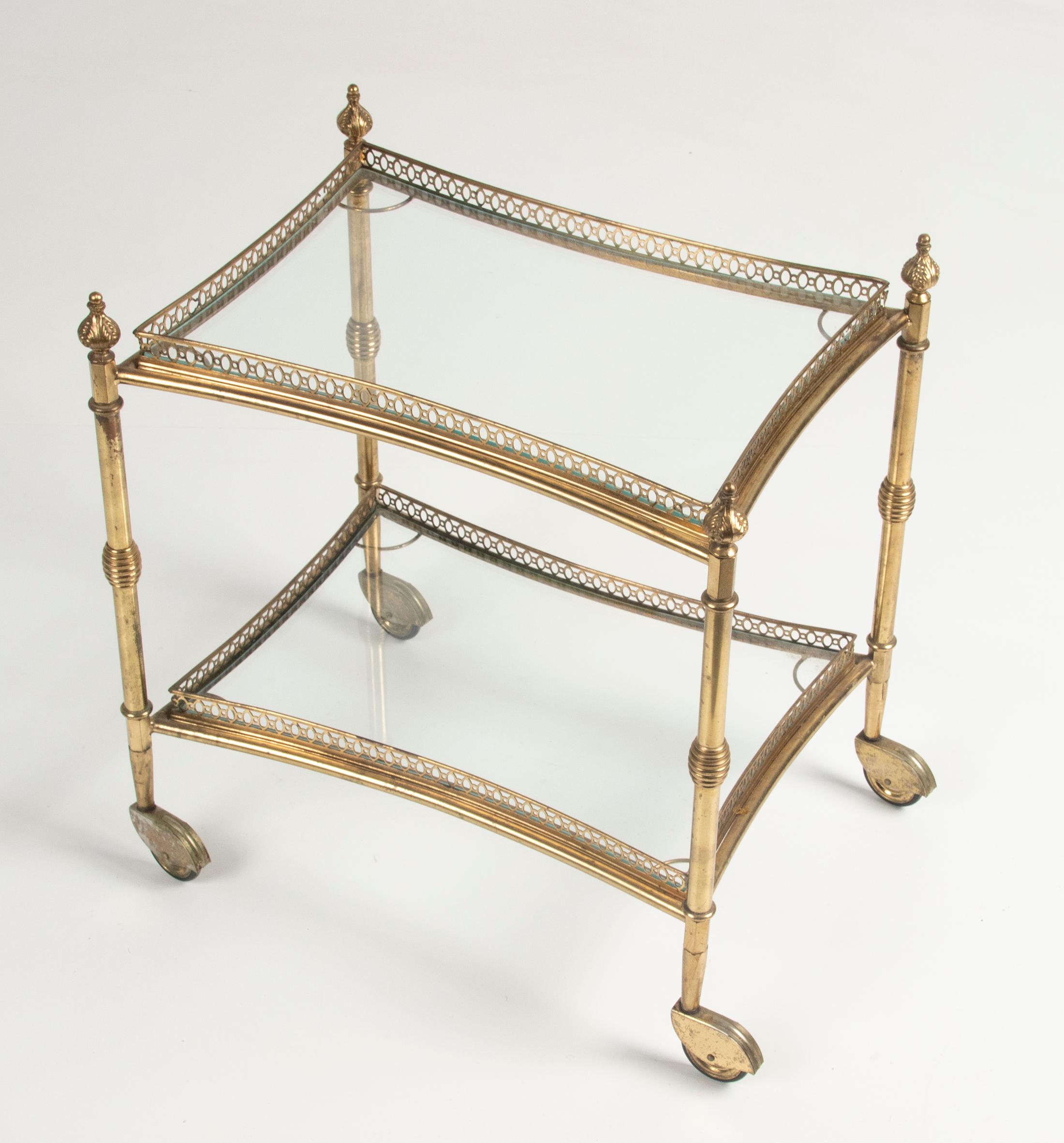 A copper mid century bar cart. The trolley has two levels of glass. The trolley have a copper cut-out raised edge. The copper swivel wheels have a little wear on the copper. It's made in France, around 1960-1970. The cart can be disassembled and can