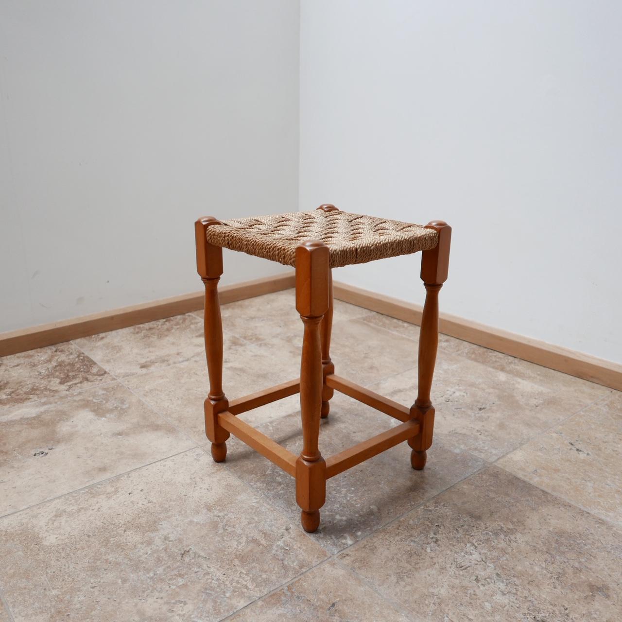 An elegant occasional stool or side table. 

French, circa 1960s. 

Wood with a braided cord seat. 

Dimensions: 30 W x 30 D x 46 H in cm. 
 