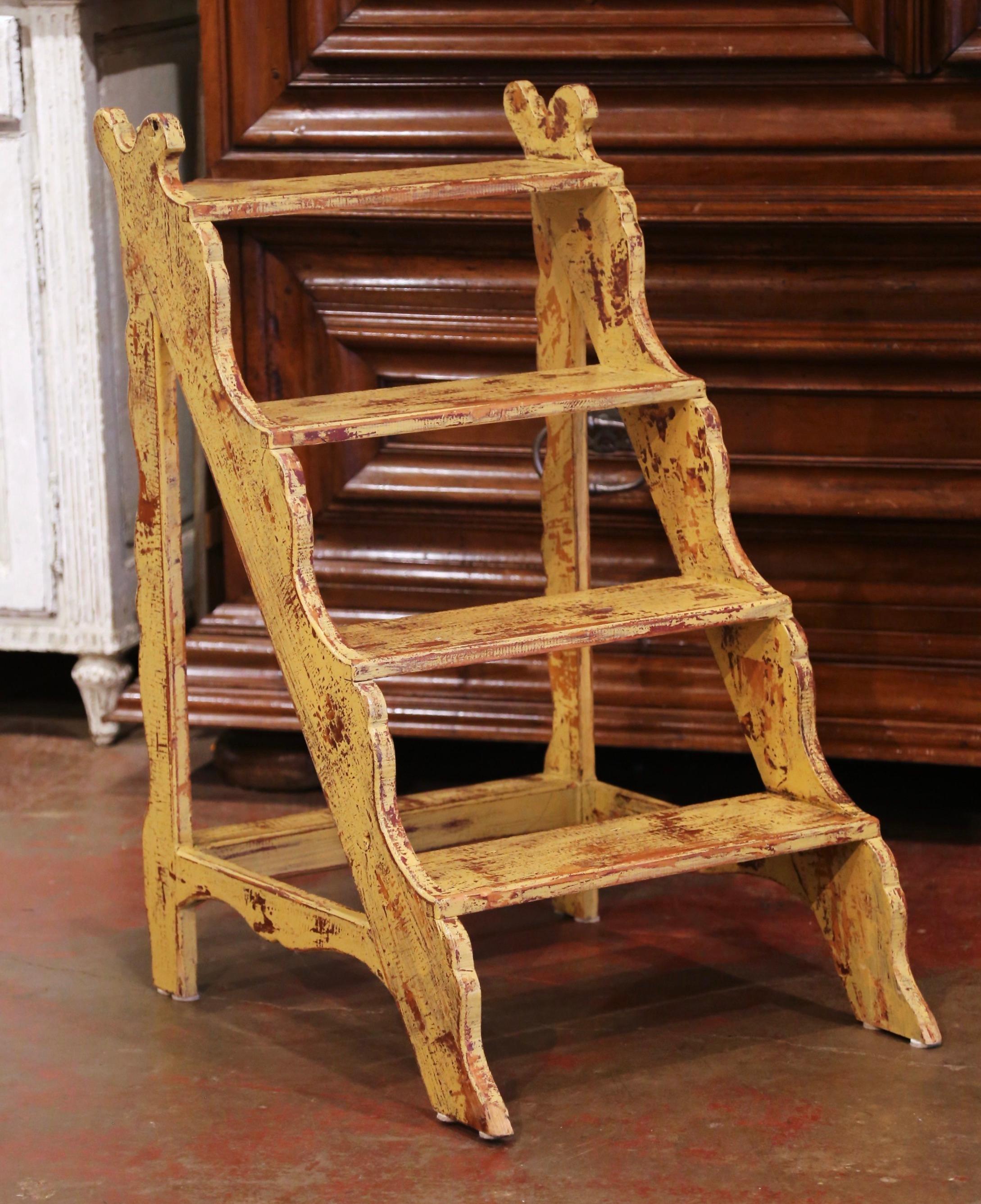 This elegant antique scalloped step ladder was created in France, circa 1970. Carved of pine, the ladder features four steps connected to a sturdy stretcher. Practical and useful, the rustic ladder is in excellent condition, and adorns a rich