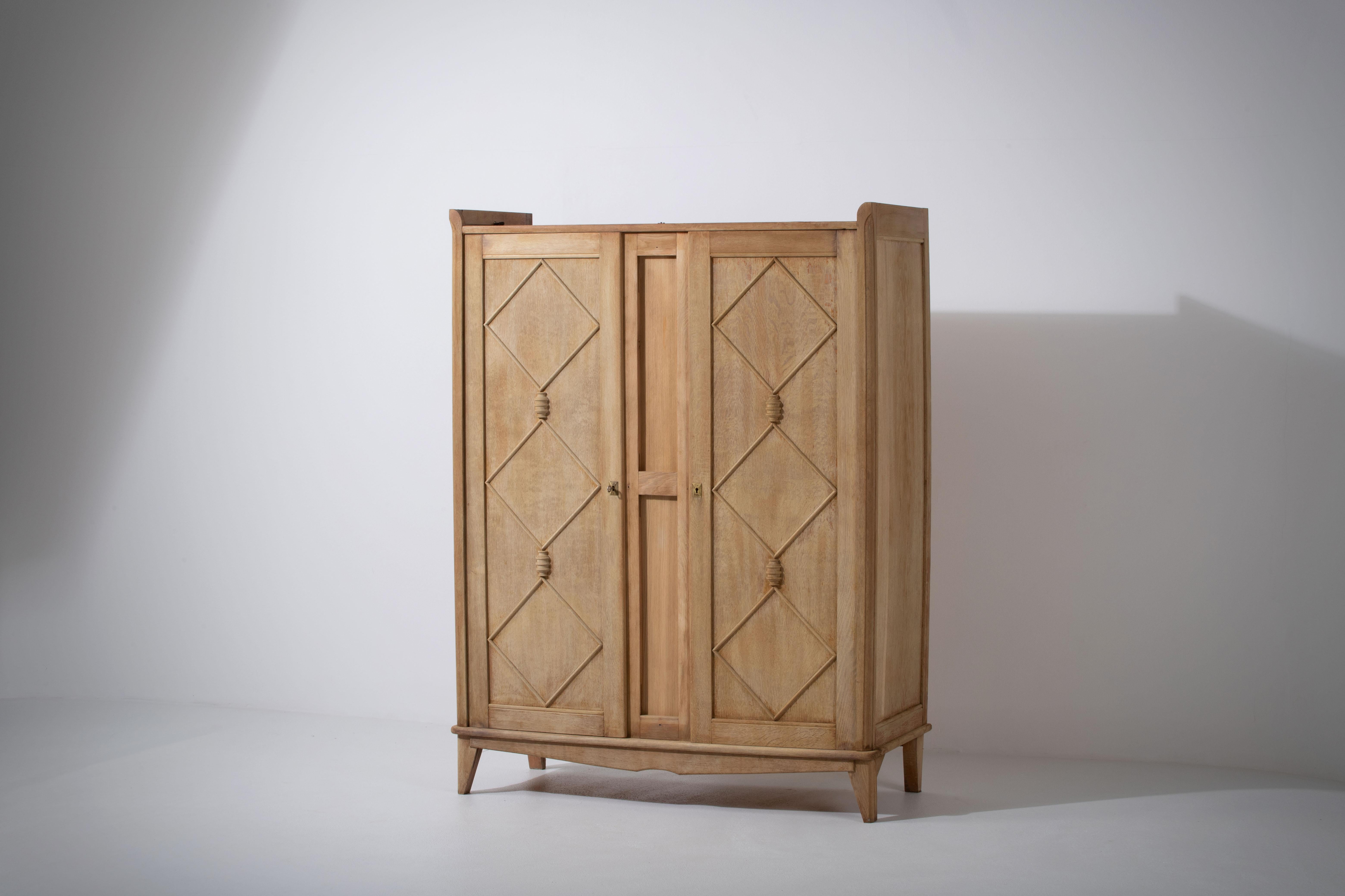 Immerse yourself in the essence of midcentury French design with this striking vintage oak wardrobe, crafted in the 1960s. The piece pays homage to the iconic Jean Royère, drawing parallels with his signature style in the form of its double doors,