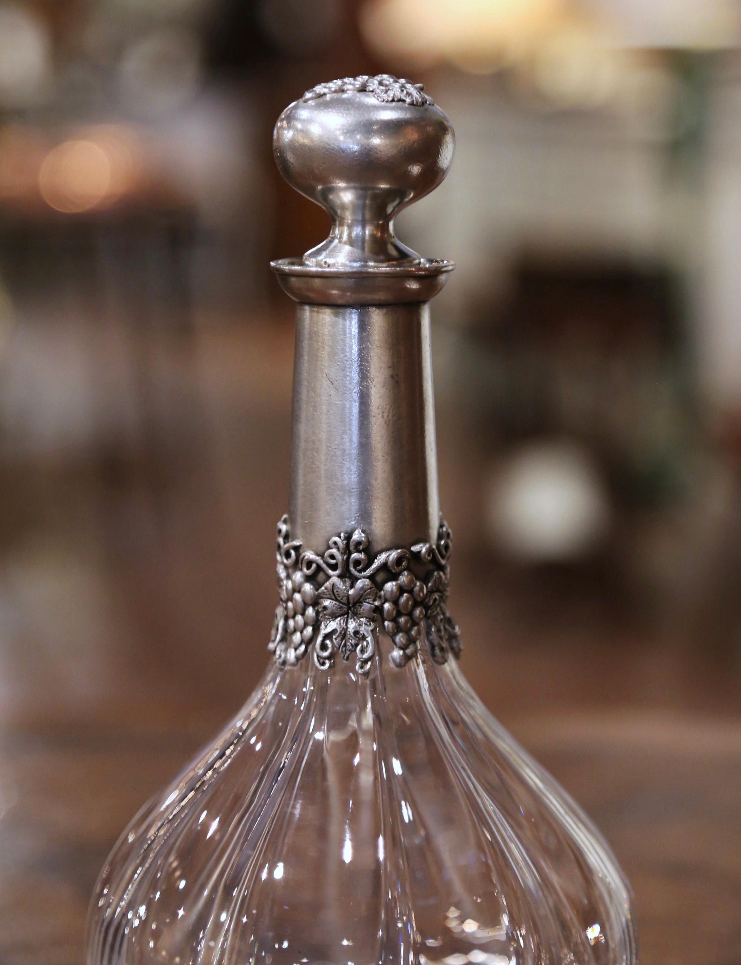 Serve your favorite Bordeaux or Cabernet sauvignon with style in this elegant antique decanter. Crafted in France circa 1960, the cut crystal carafe stands on a round pewter base decorated with grape and leaf motifs. The tall neck is dressed with