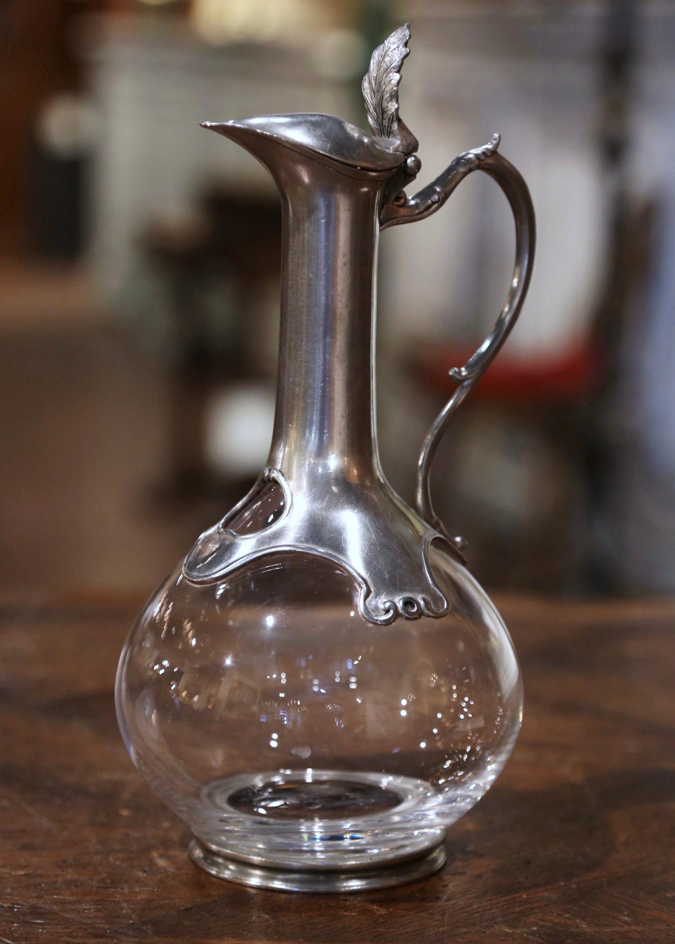 Serve your favorite Bordeaux or Cabernet Sauvignon with style in this elegant antique decanter. Crafted in France circa 1960, the cut crystal carafe stands on a round pewter base. The tall neck with side handle is dressed with pouring spout and